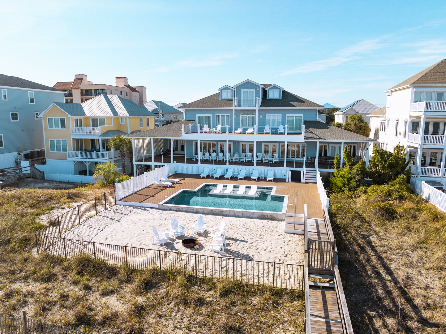 Stunning beachfront property with private pool and expansive outdoor entertaining spaces in a picturesque coastal neighborhood.