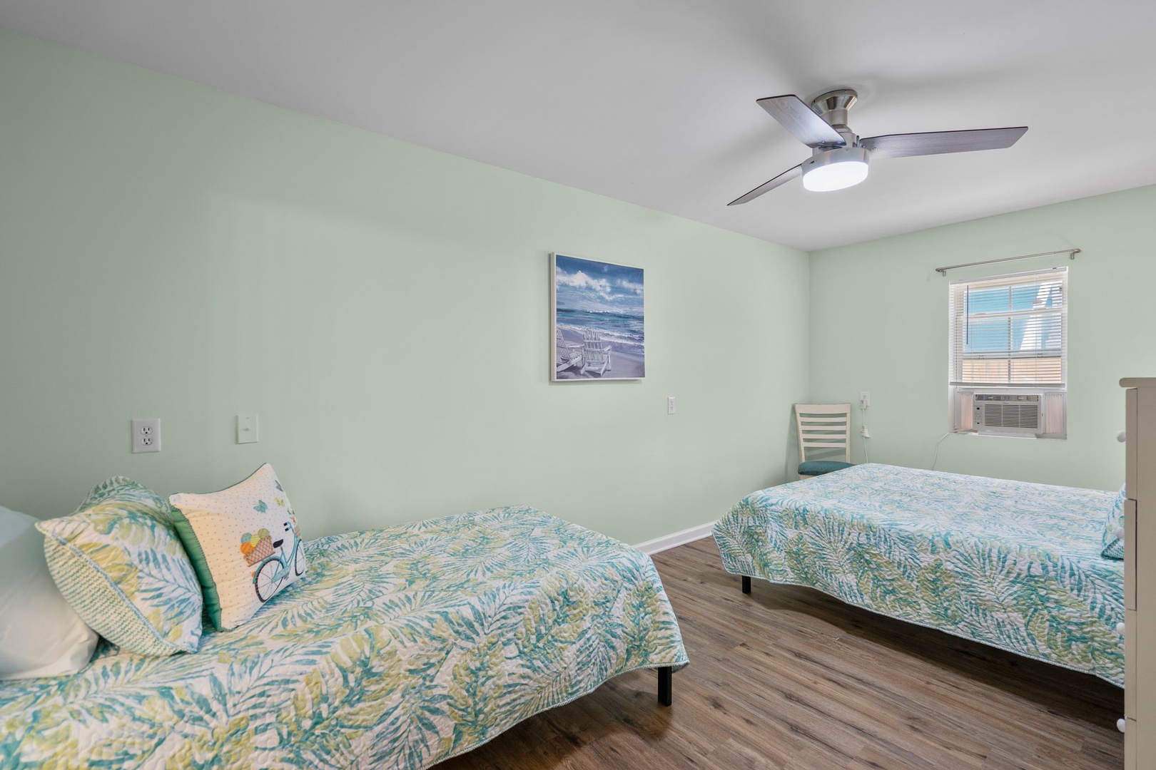 Drift off in your tropical-themed bedroom with twin beds, soothing mint walls, and a gentle ceiling fan keeping you cool all night long.
