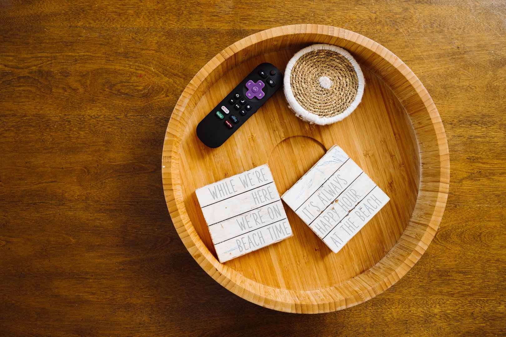 Unwind with your remote and thoughtful touches in this cozy wooden tray—your perfect setup for relaxing evenings.