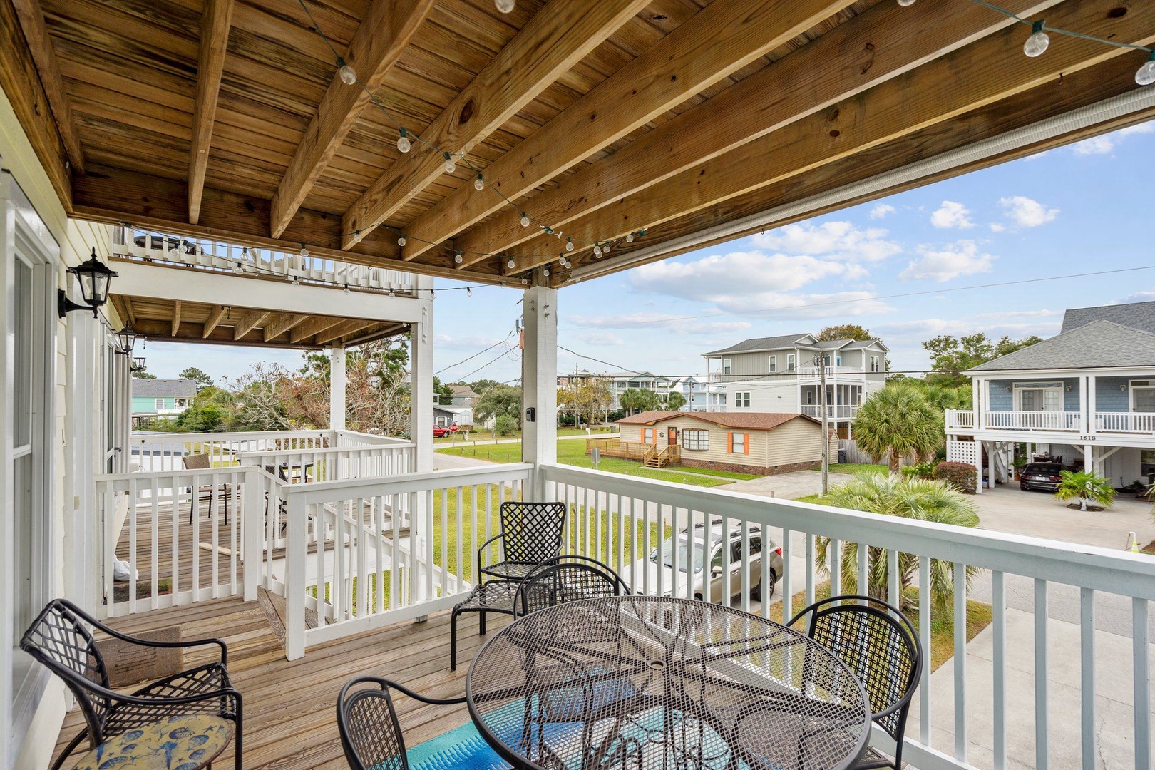 Your private covered deck invites you to savor morning coffee or evening meals while overlooking the peaceful coastal neighborhood.