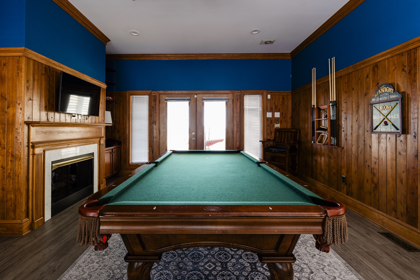 Challenge friends to a game in your private billiards room, featuring rich wood paneling, a cozy fireplace, and professional-grade table.