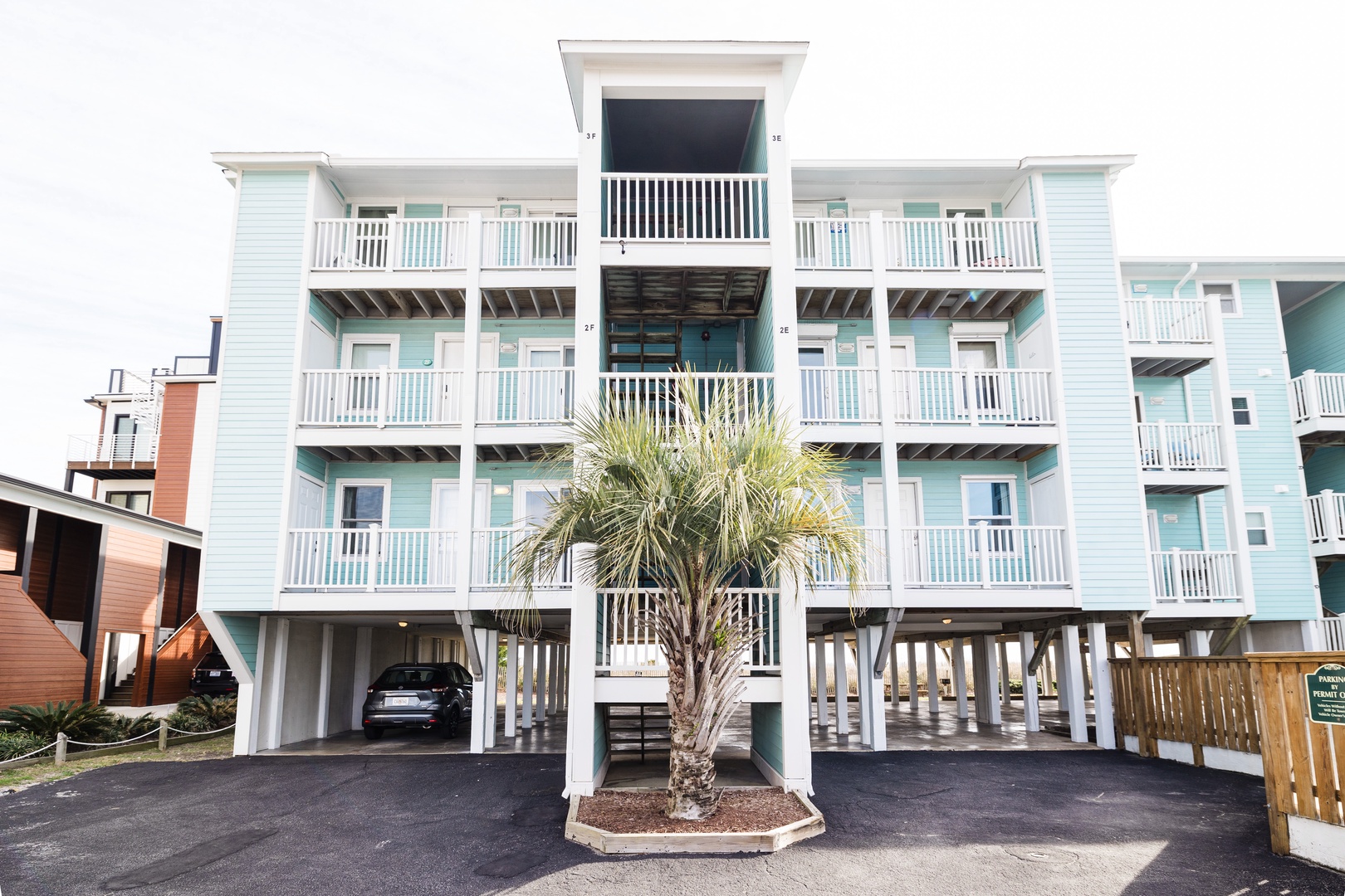 Coastal charm meets convenience with covered parking and private balconies overlooking tropical landscaping.