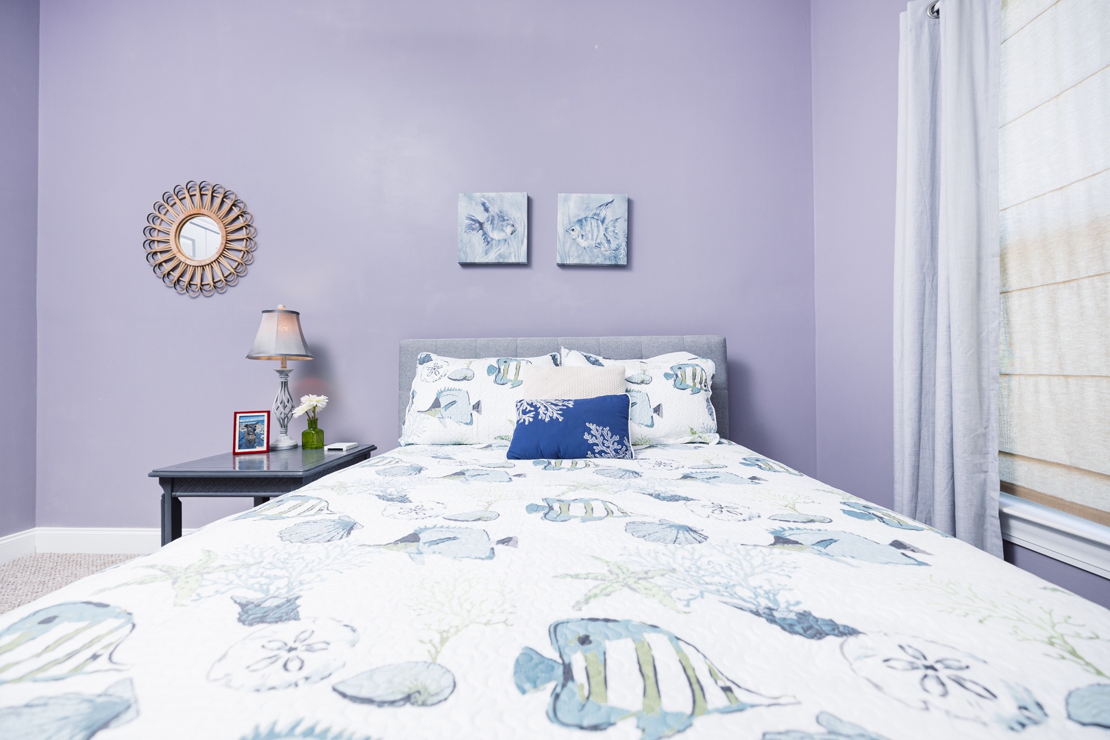 Rest peacefully in your coastal-themed bedroom, where soft lavender walls and ocean-inspired bedding create a serene seaside sanctuary.