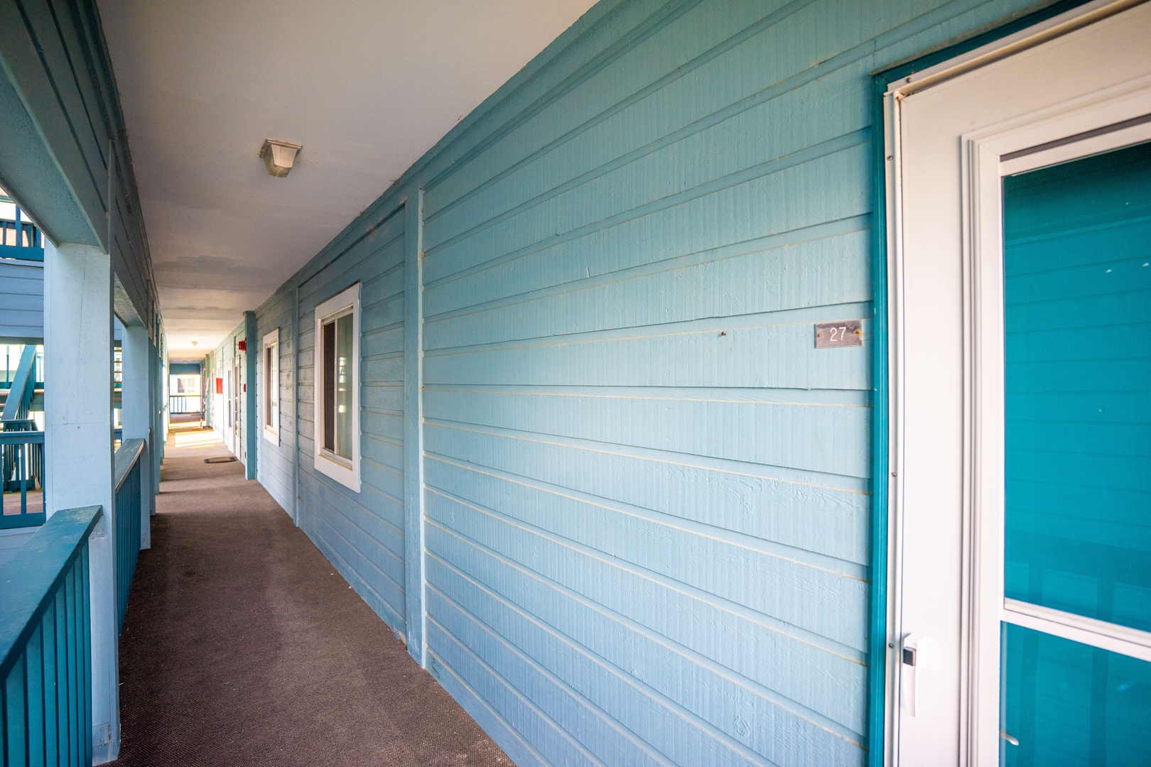 Step into your coastal retreat along this charming turquoise corridor, where beach house vibes welcome you to your seaside escape.