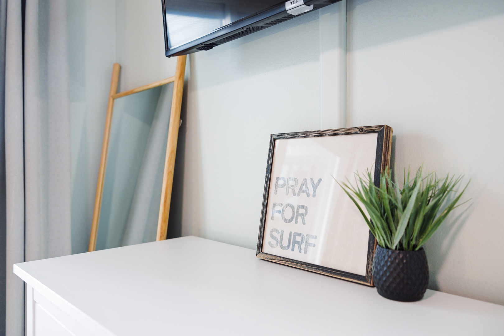 Your bright, cheerful space features thoughtful touches like surf-inspired art and fresh greenery to help you feel at home.