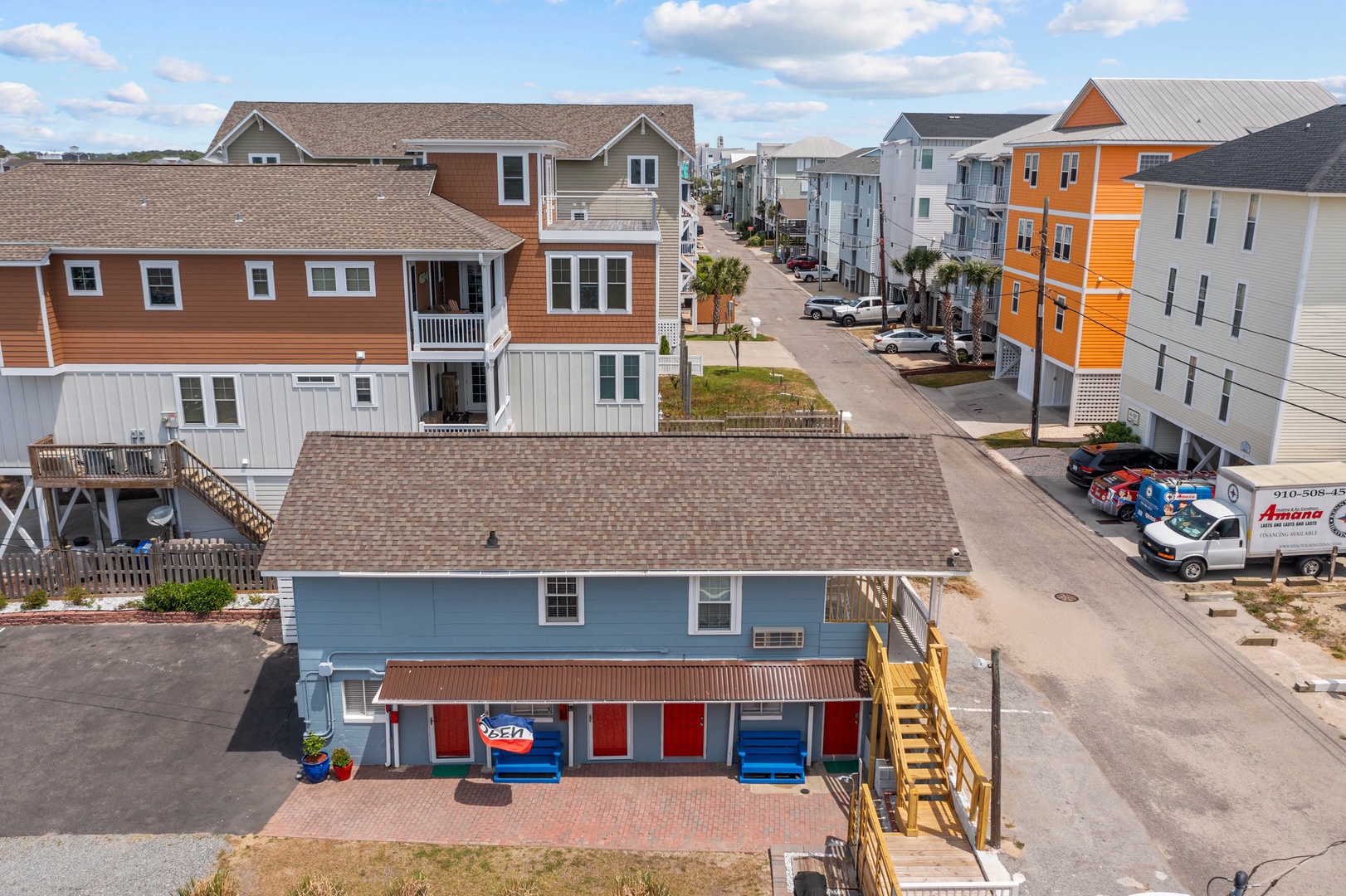 Charming beach community with colorful coastal homes, convenient parking, and peaceful residential streets perfect for your seaside getaway.
