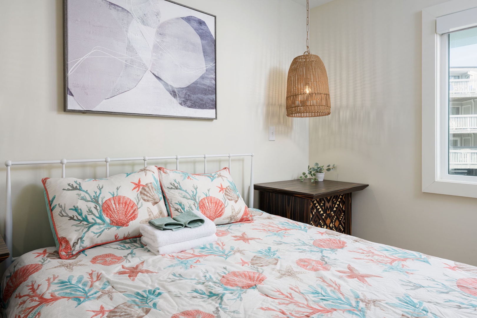 Drift into peaceful sleep surrounded by charming coastal bedding and warm wicker lighting in your cozy retreat.