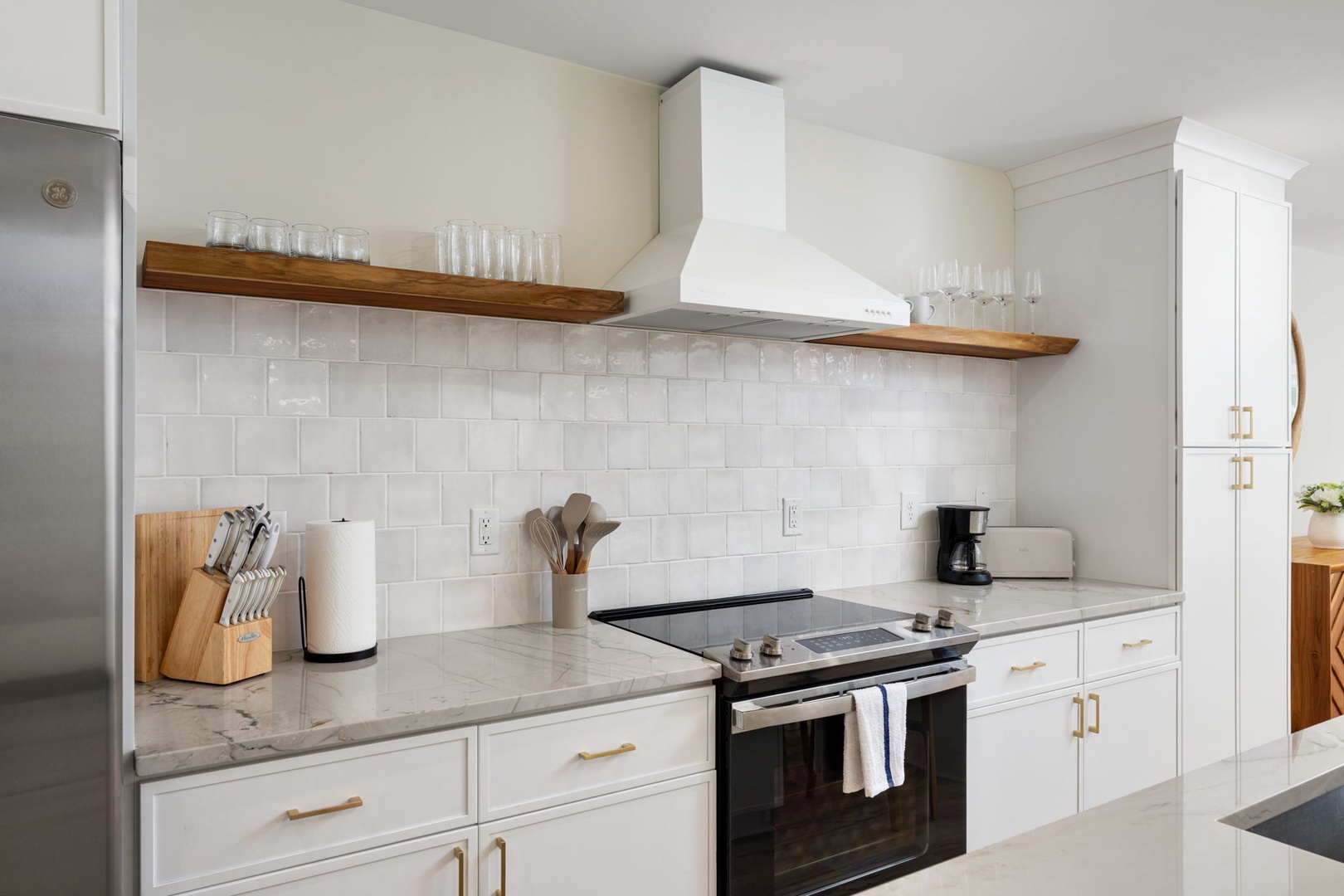 Your gourmet kitchen features marble countertops, professional appliances, and warm wood accents - perfect for creating memorable meals together.