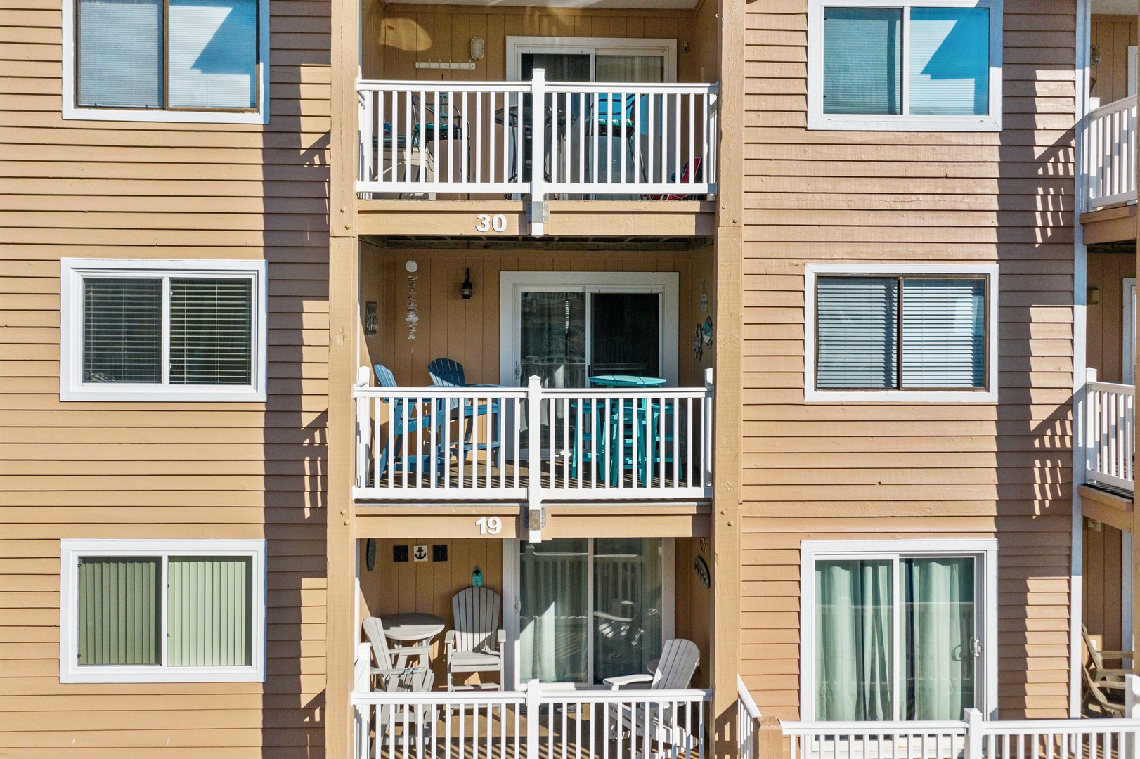 Your private balcony awaits with comfortable seating and sliding glass doors that flood your space with natural light.