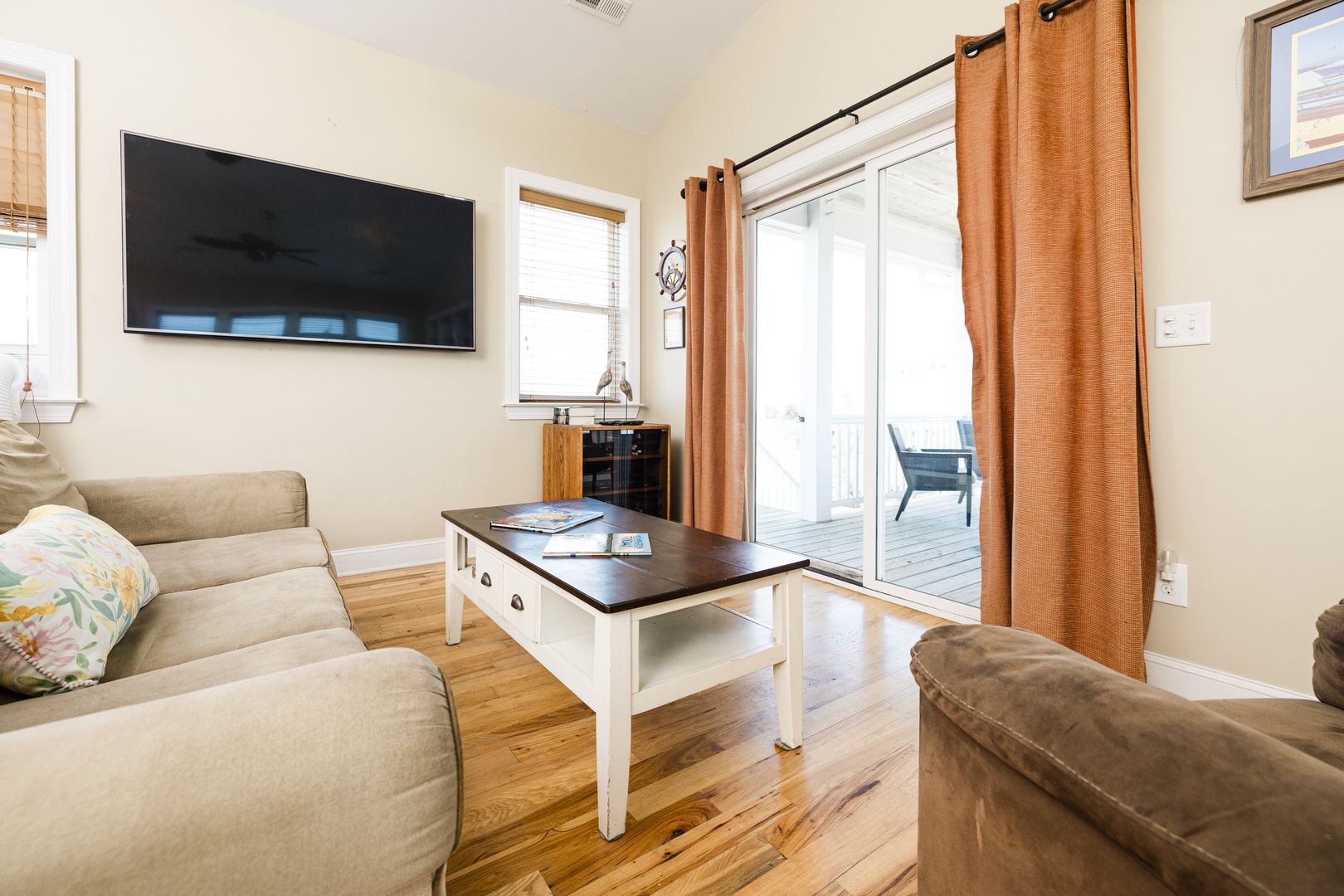 Unwind in your cozy living room with plush seating, entertainment, and sliding door access to your private outdoor space.