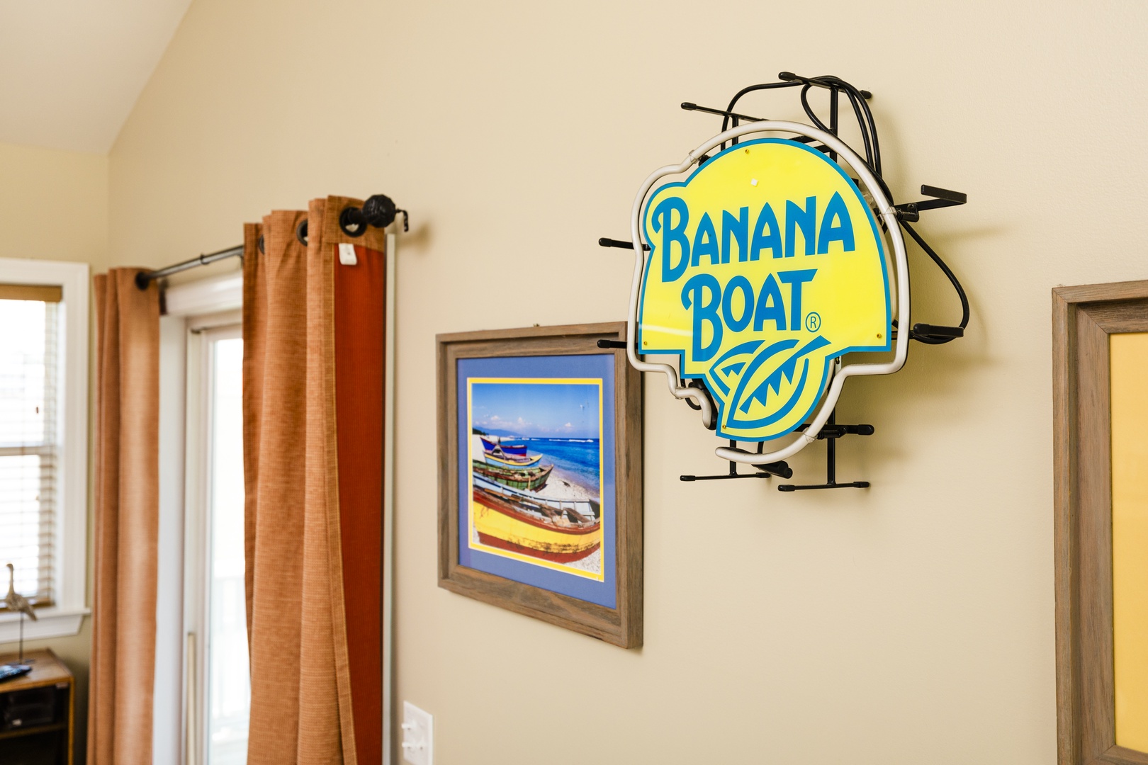 Your tropical-themed space captures island vibes with boat artwork and bright yellow accents throughout.