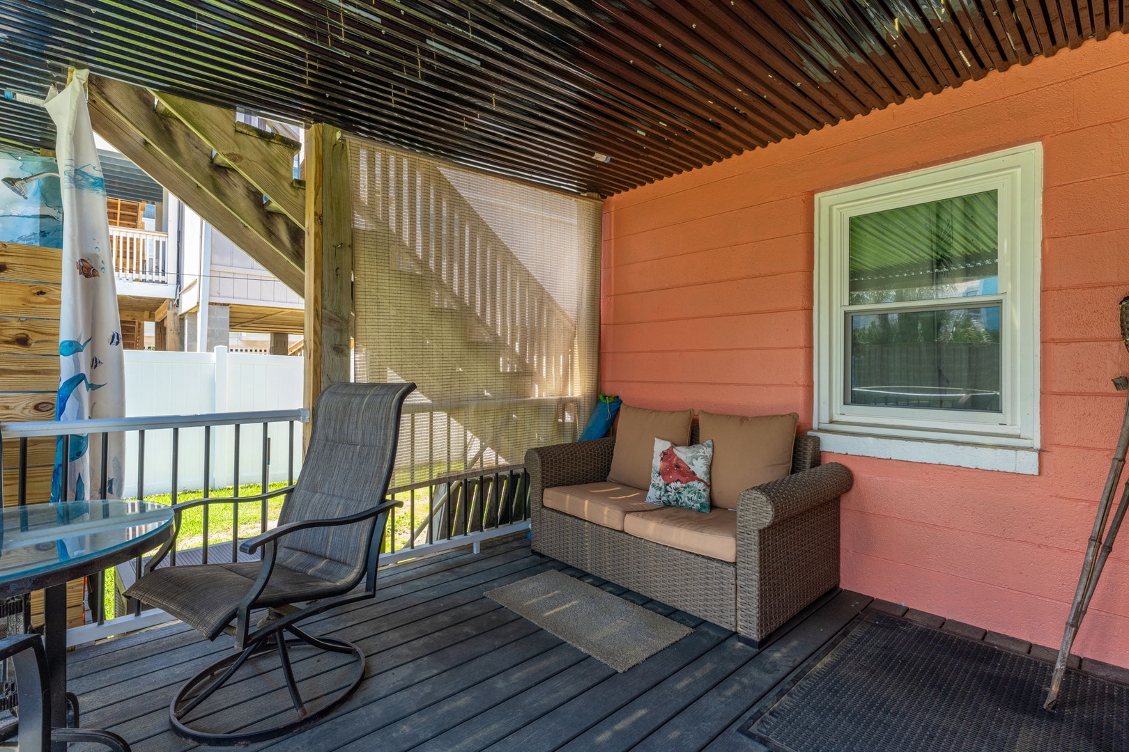 Your private patio offers comfortable seating where you can unwind with morning coffee or evening conversations, all beneath a stylish covered ceiling that provides cool shade.