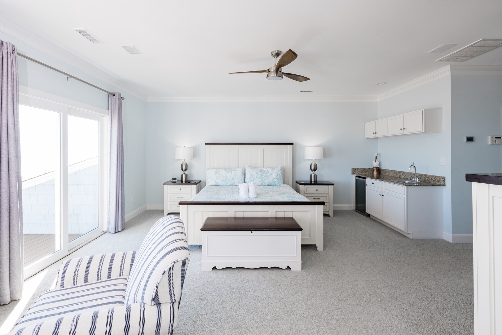 Your spacious suite combines bedroom comfort with kitchenette convenience, featuring coastal-inspired decor and modern amenities for extended stays.