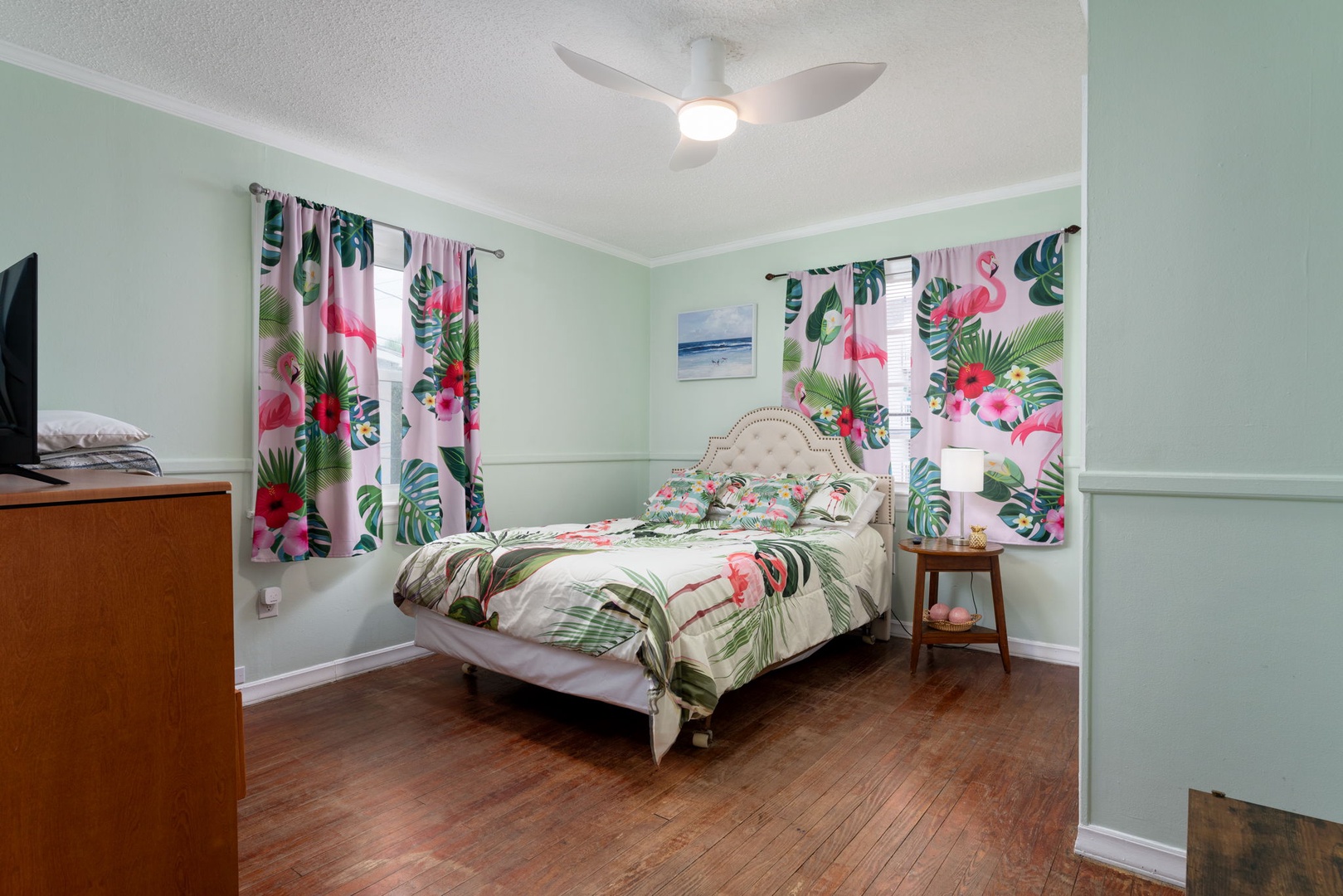 Wake up refreshed in your tropical paradise bedroom with vibrant flamingo bedding and cheerful curtains creating the perfect vacation vibe.