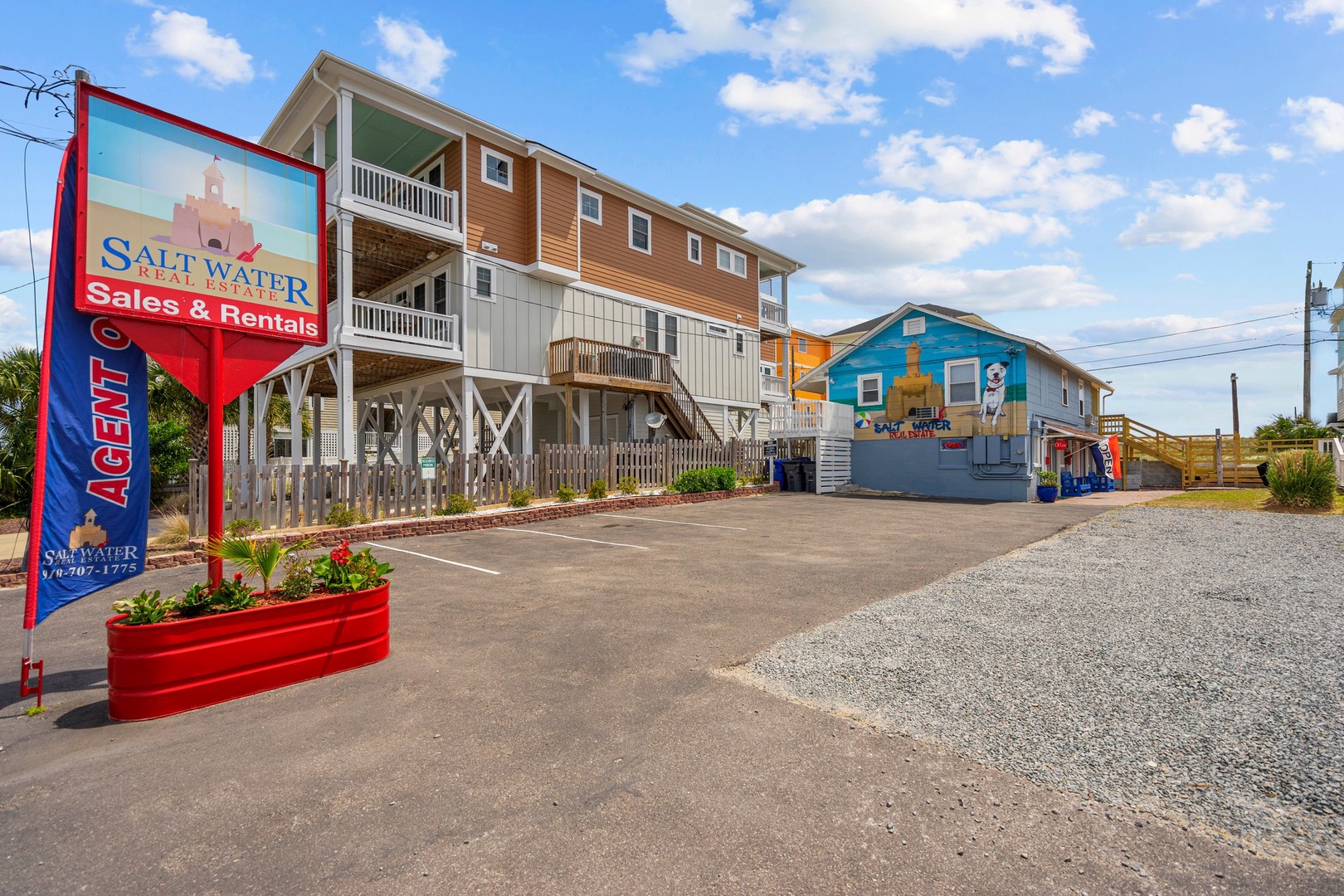 Salt Water Realty office and colorful beachside properties create a vibrant arrival area for guests seeking coastal vacation rentals.