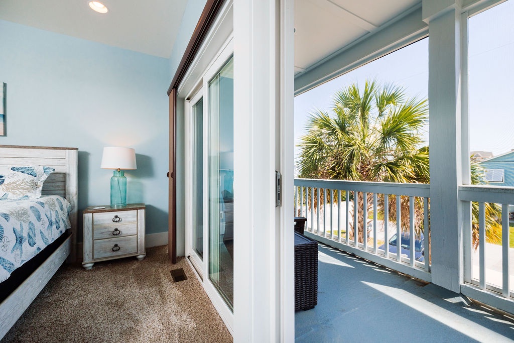Wake up to tropical palm views from your bright bedroom, then step onto your private balcony for morning coffee in the coastal breeze.