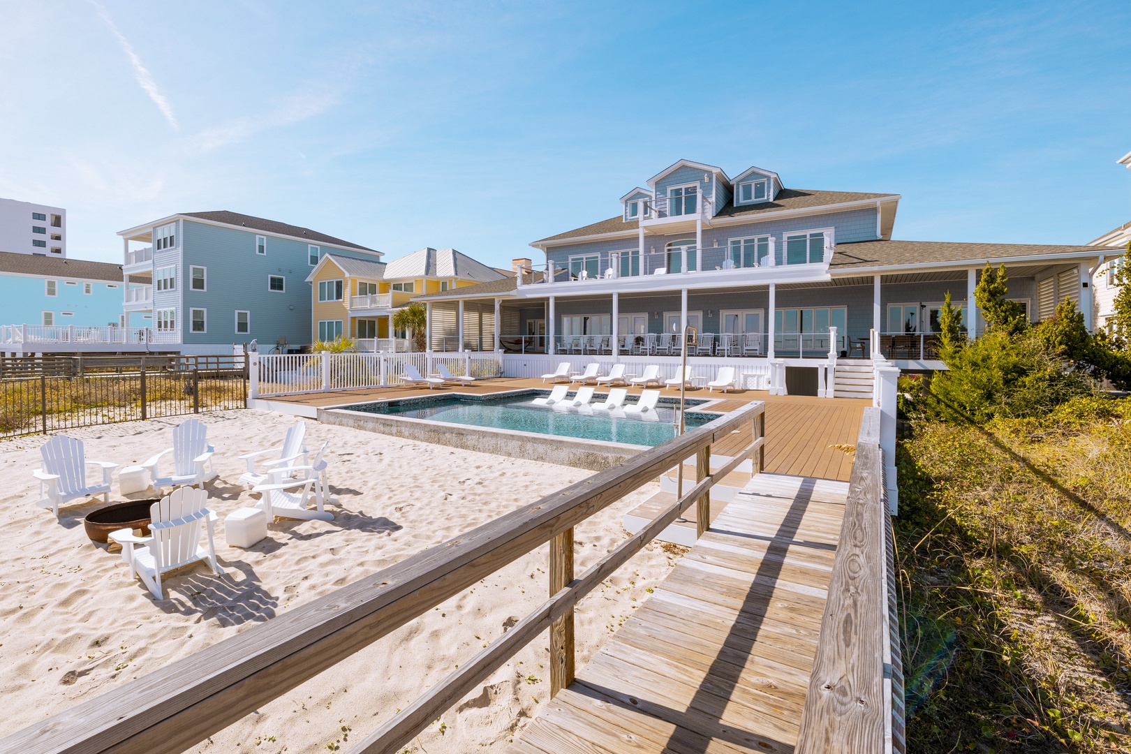 Beachfront property featuring private pool, sun deck, and direct beach access in a coastal neighborhood setting.