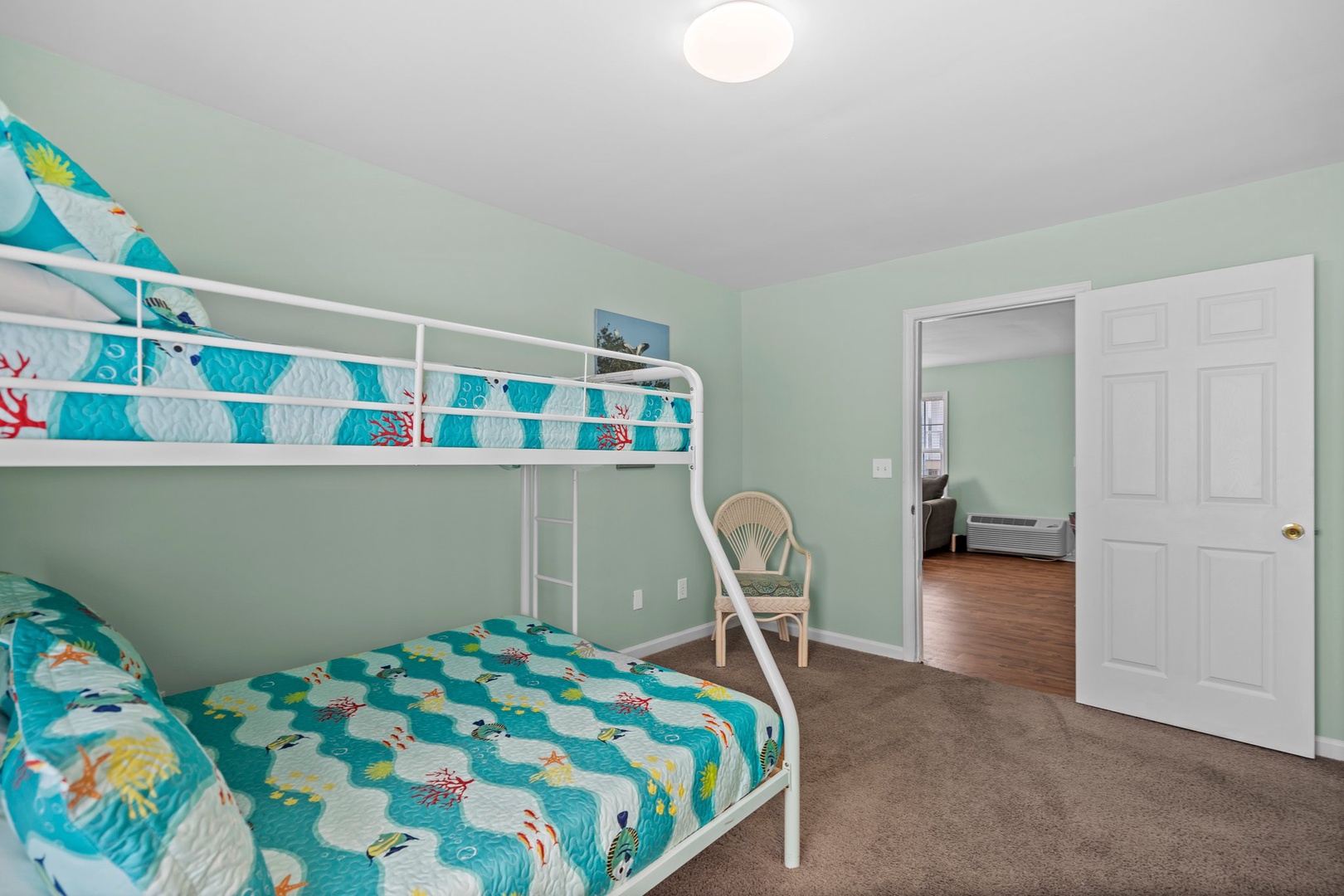 Your kids will love this ocean-themed bunk bed room with playful sea life bedding and calming mint walls.