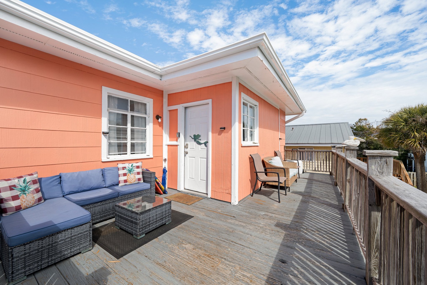 Relax on your private deck with comfortable seating and coastal breezes, where afternoon conversations feel effortless.
