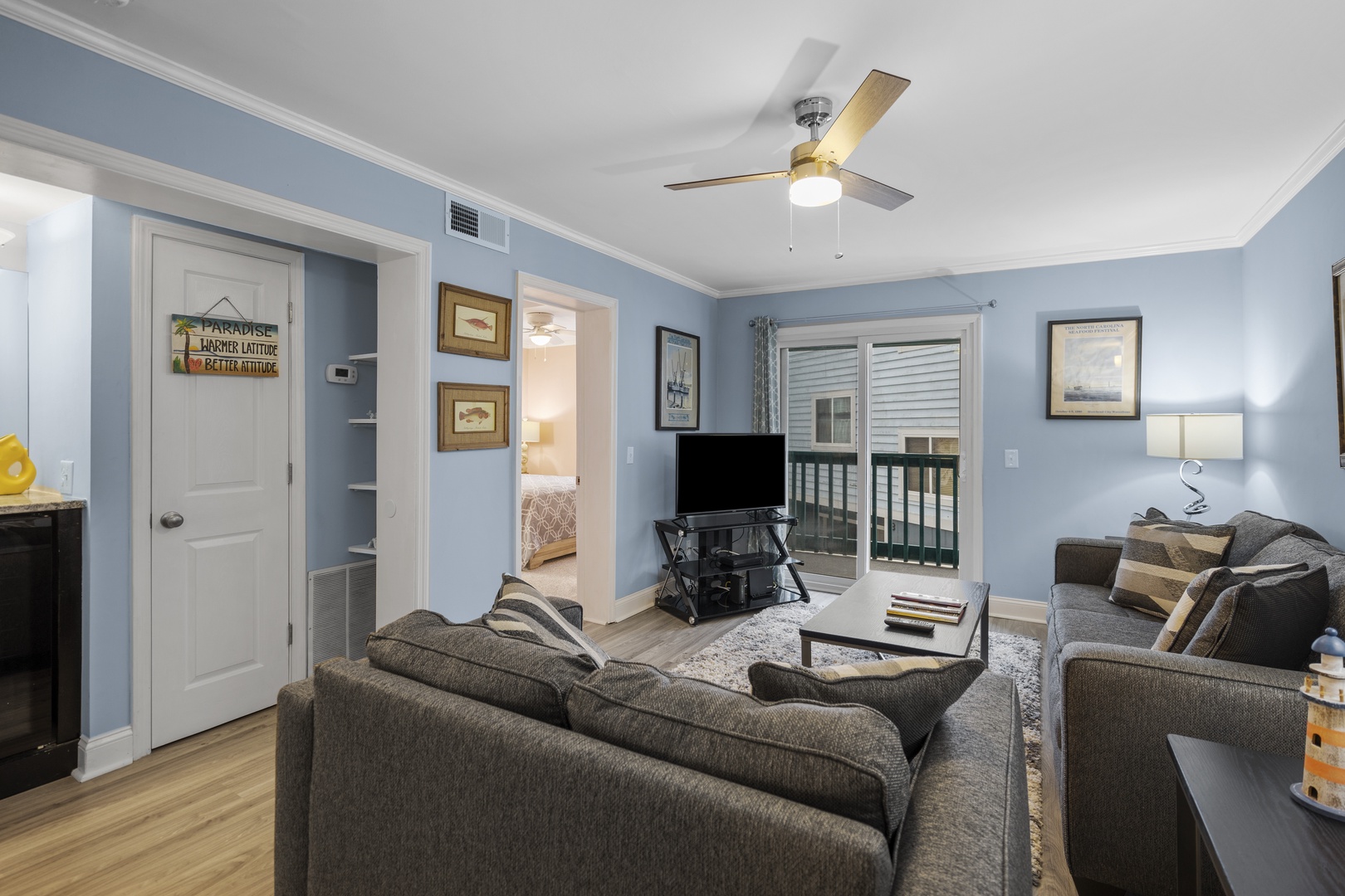 Unwind in your spacious living room with comfortable seating, entertainment, and coastal touches that create the perfect beach getaway atmosphere.