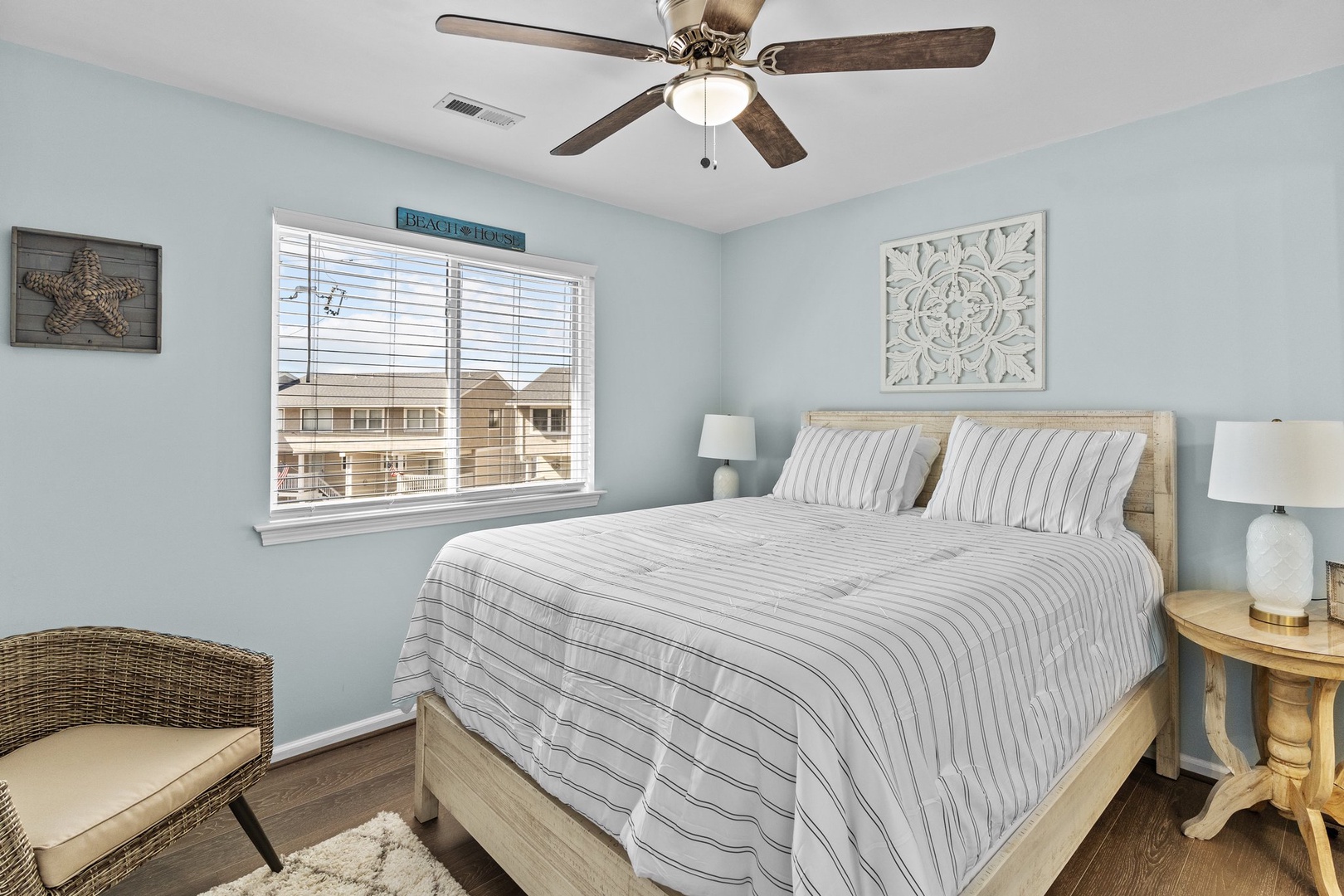 Wake up refreshed in your coastal-inspired bedroom featuring soft blue walls, comfortable bedding, and calming decor.