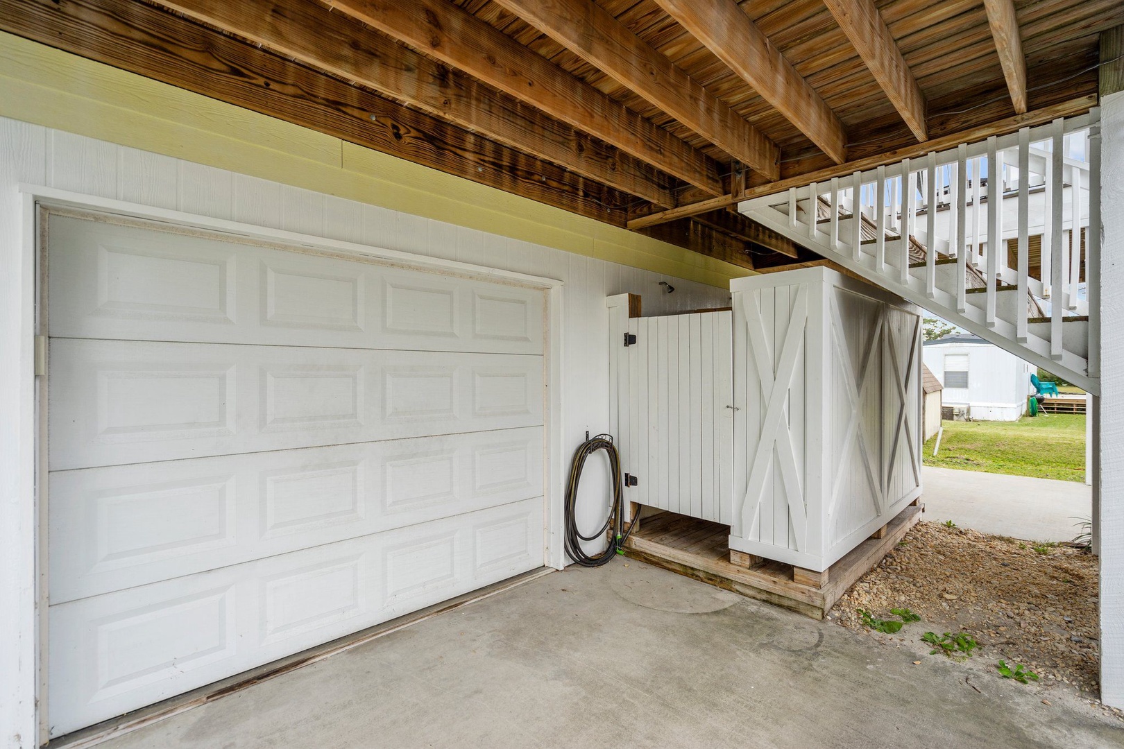 Secure parking awaits beneath rustic wood beams, with convenient storage space for your gear and easy access to your retreat.