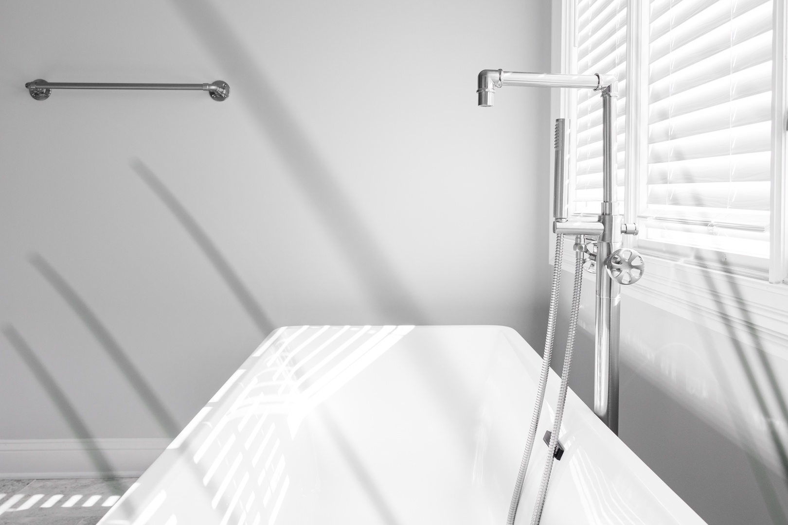 Soak in your private bathtub while natural light streams through shutters, creating a peaceful retreat for relaxation.