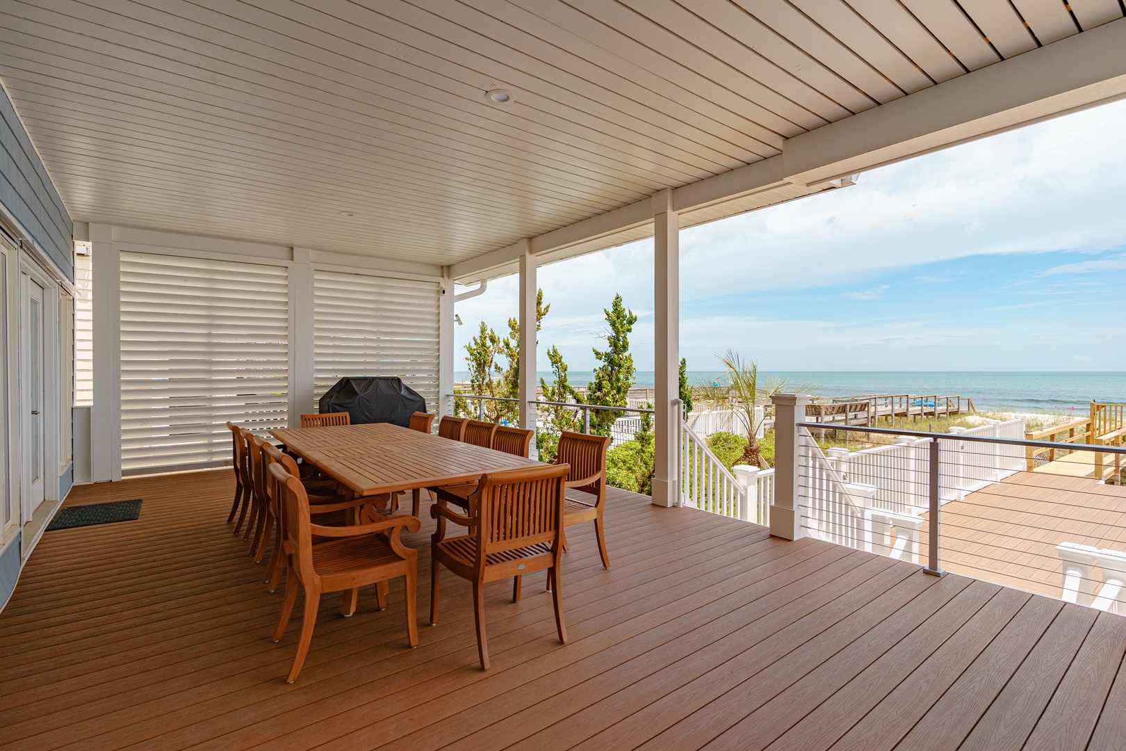Your covered deck offers oceanfront dining with stunning sea views and direct beach access.
