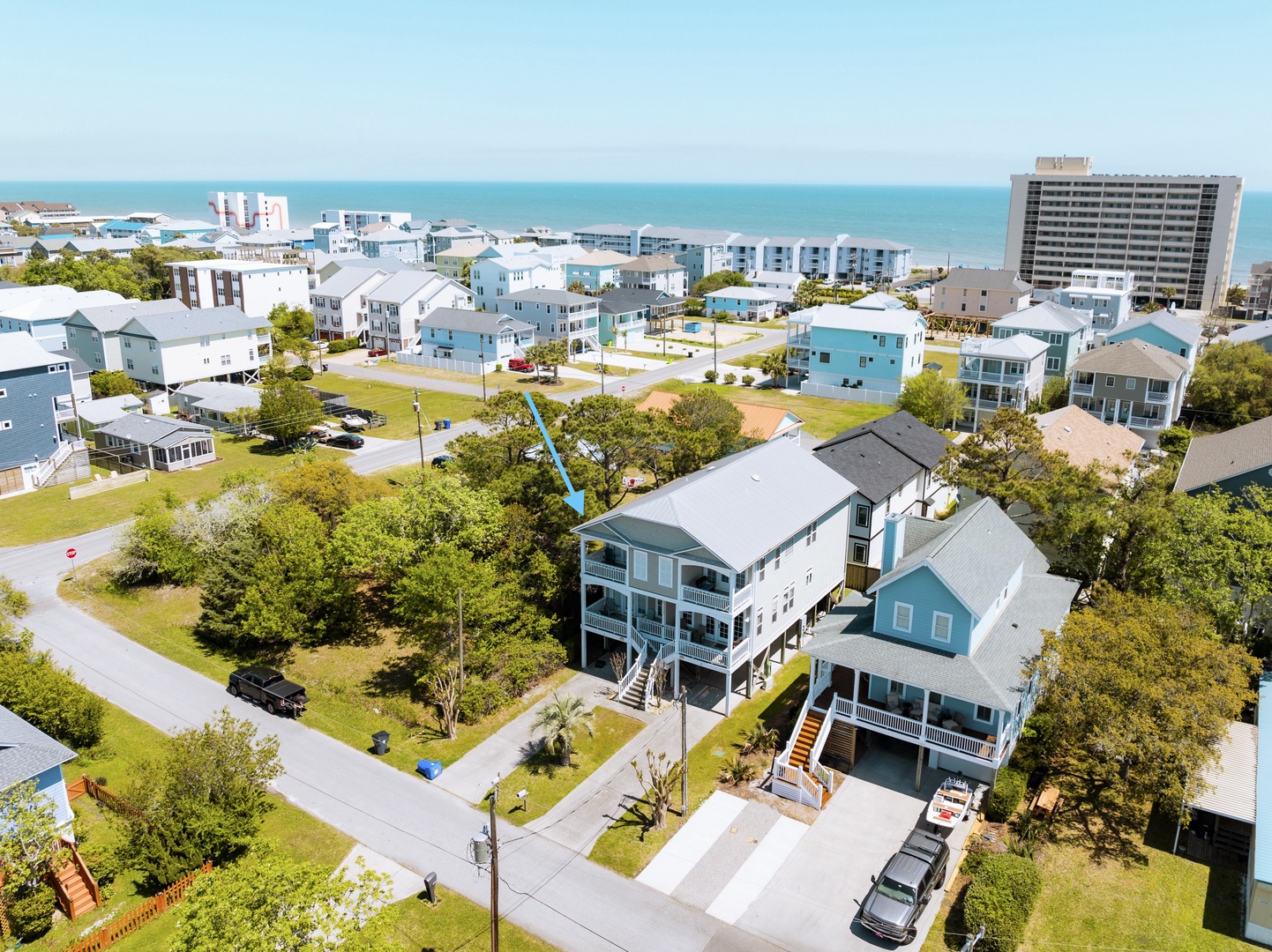 Coastal vacation rental community with easy beach access, surrounded by mature trees and peaceful neighborhood streets.