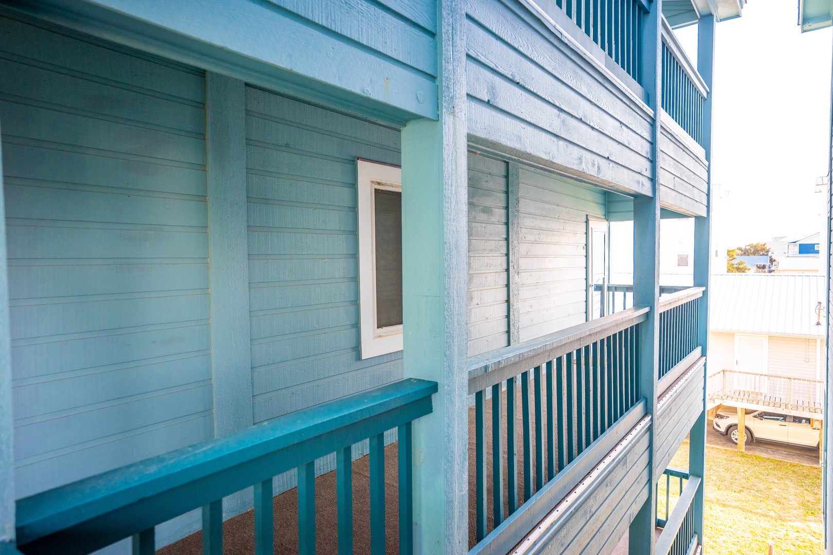 Coastal charm meets comfort with weathered turquoise siding and wraparound decking that captures the seaside spirit.