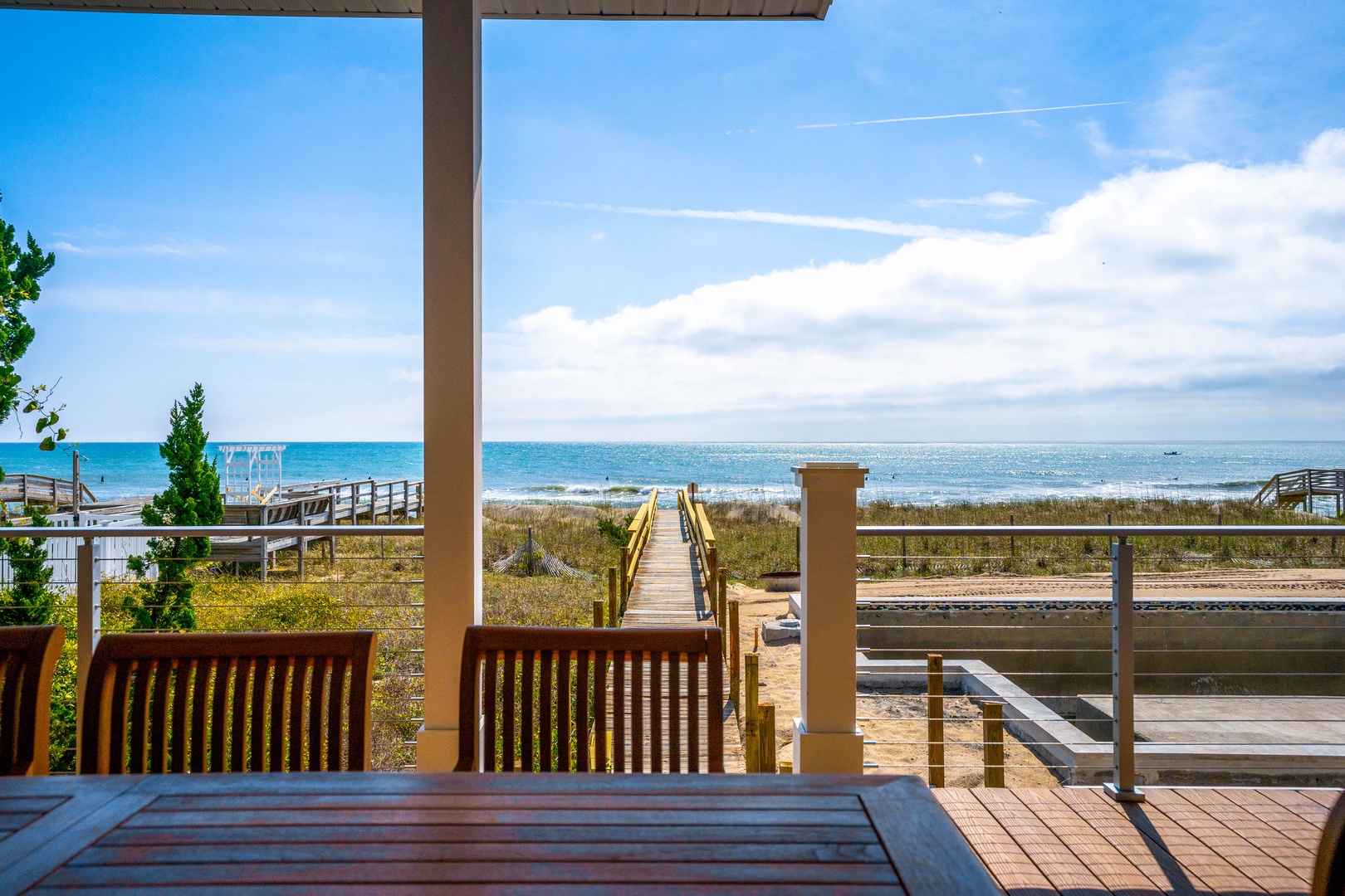Oceanfront deck overlooking pristine beach with direct boardwalk access to the shore.