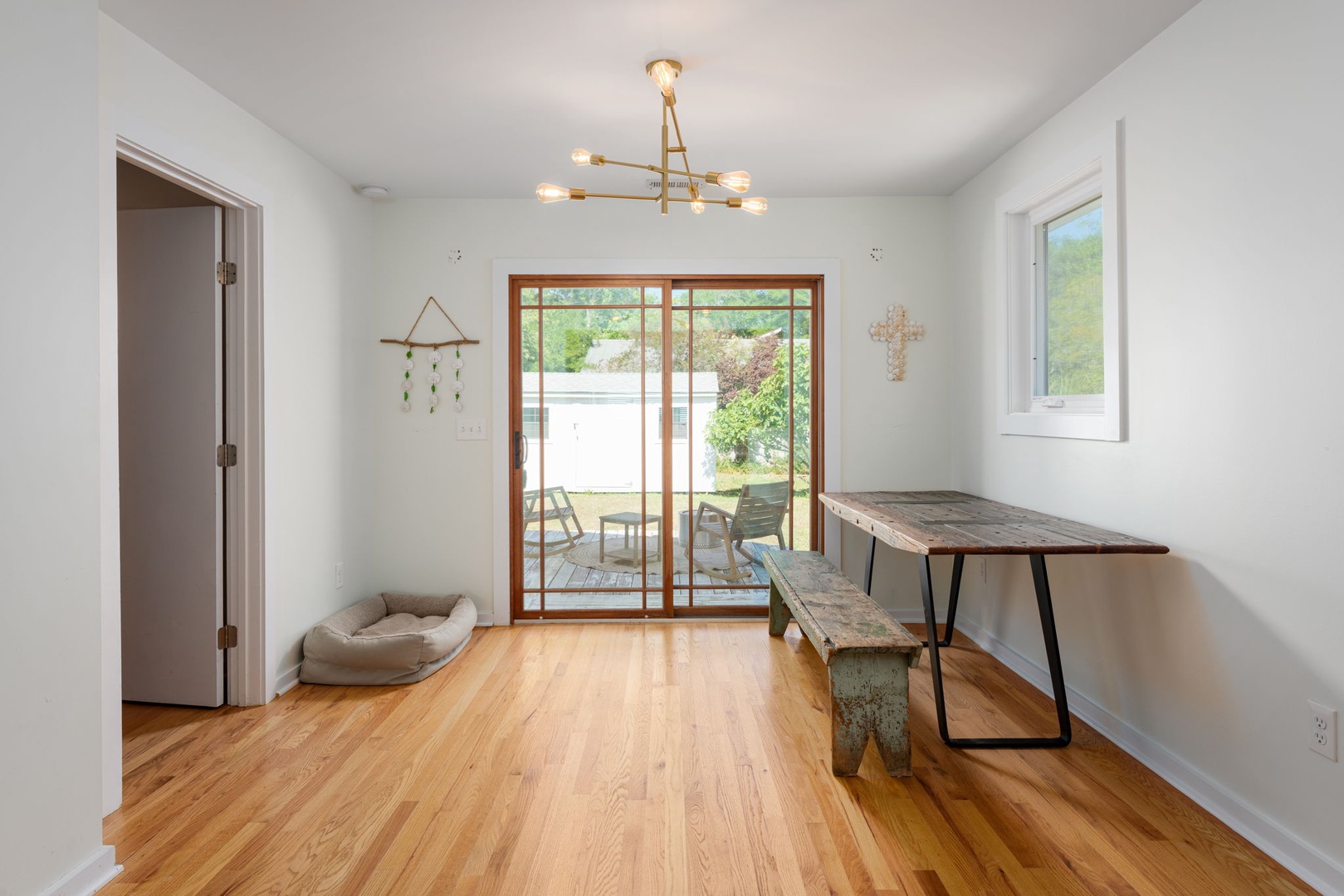 Relax in your bright dining space with warm wood floors, modern lighting, and sliding doors opening to your private patio.