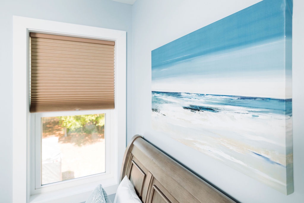 Wake up to coastal serenity in your peaceful bedroom, where ocean-inspired artwork and soft natural light create the perfect retreat.