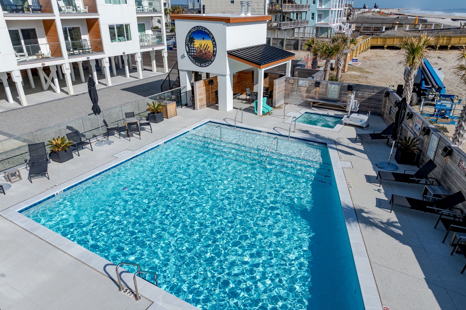 Sparkling pool area awaits your perfect beach getaway with crystal-clear waters and comfortable lounge seating.