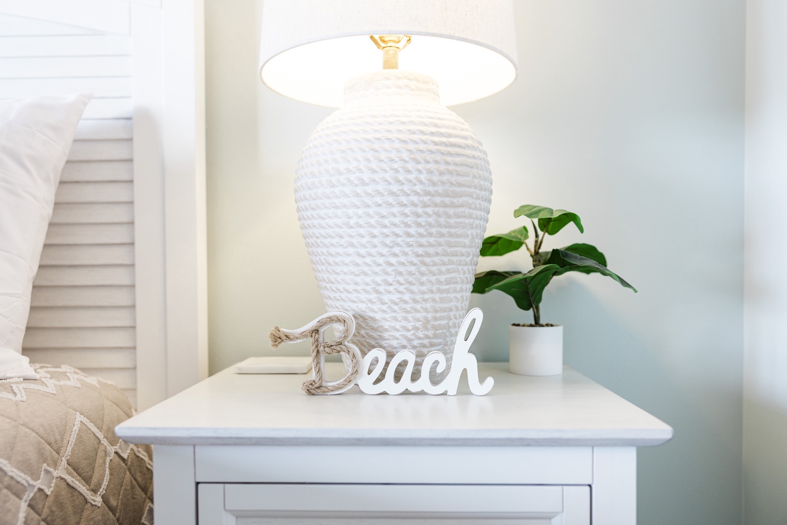 Your bedside table welcomes you with coastal charm—soft textures, warm lighting, and beachy vibes for ultimate relaxation.