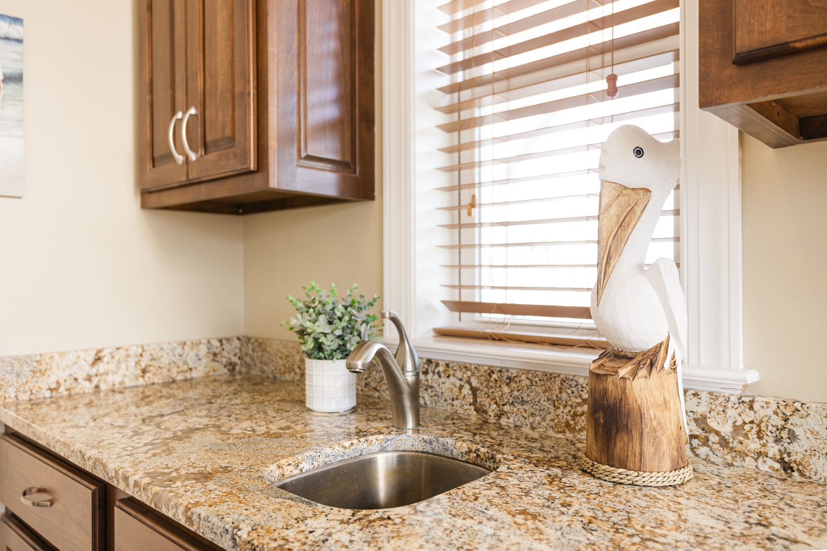 Step into your fully equipped kitchen where granite counters and warm wood cabinets create the perfect space for your culinary adventures.