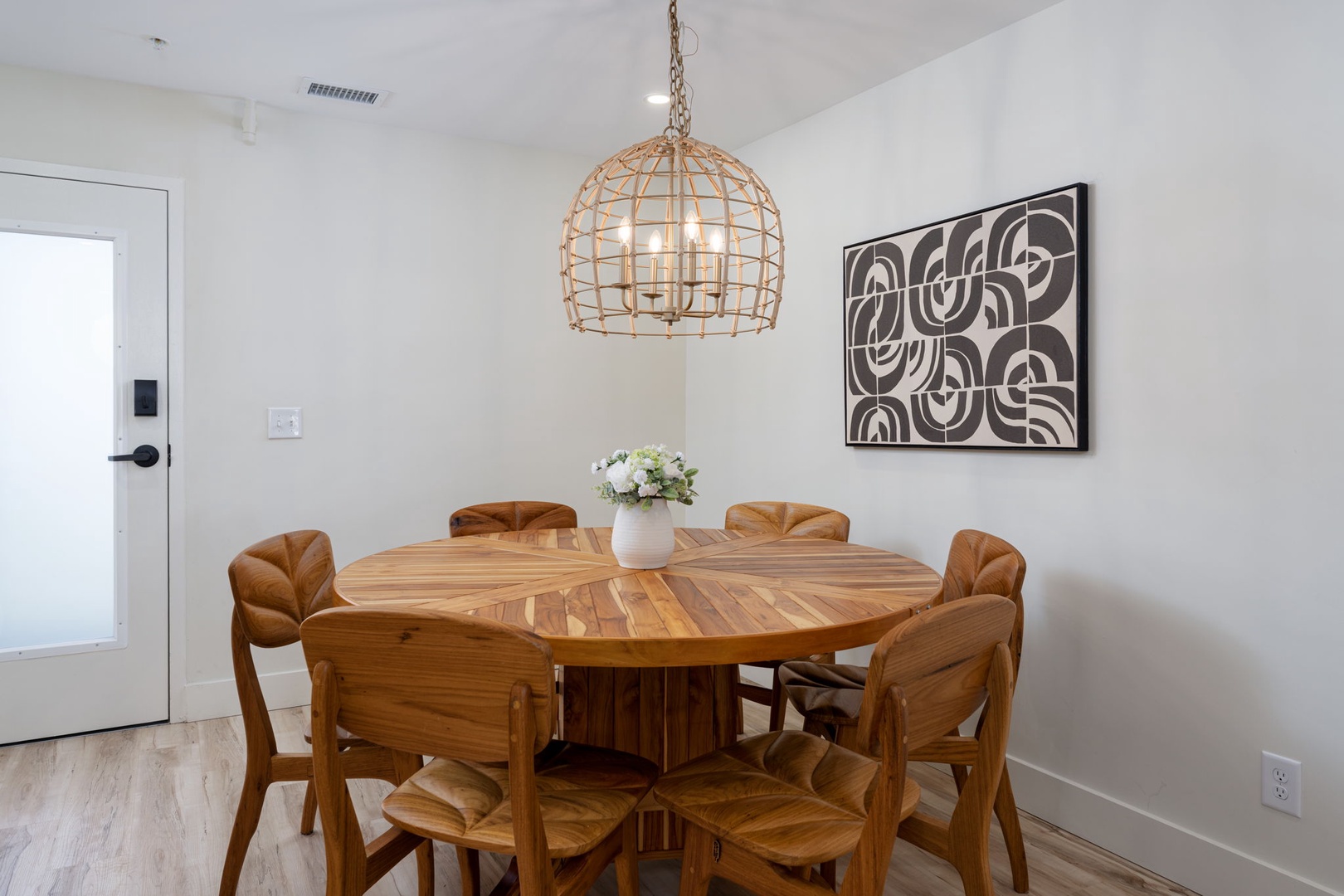 Gather around this stunning round table where warm wood meets modern style, perfect for sharing meals and making memories together.