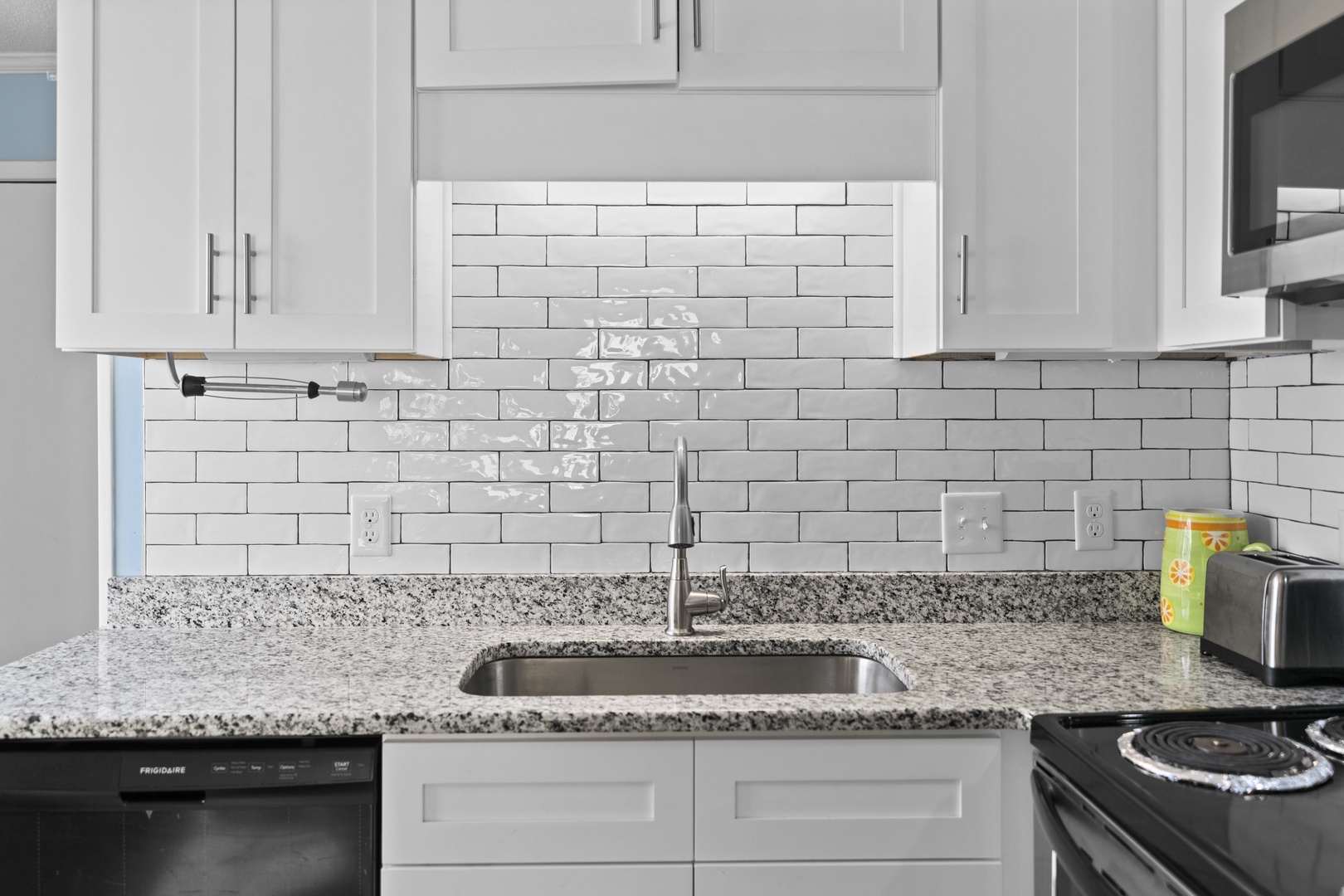 Your modern kitchen features granite counters, white subway tile backsplash, and stainless steel appliances for effortless meal preparation.