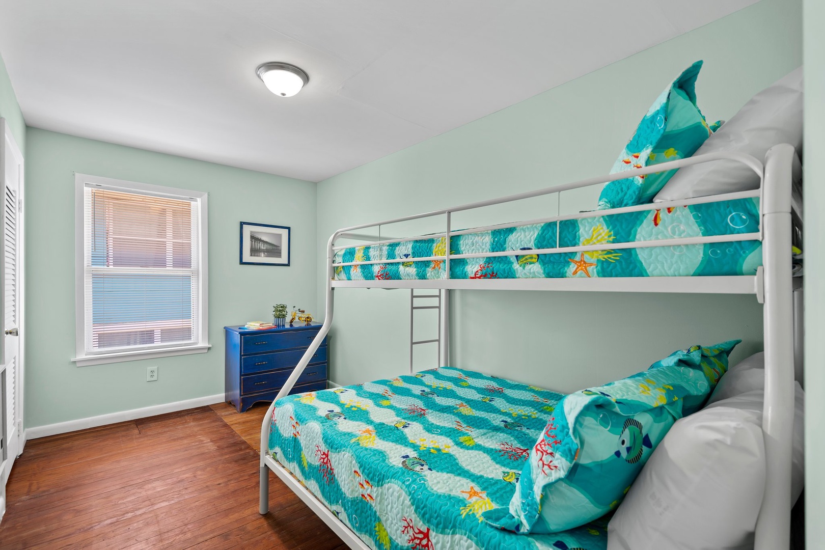Your kids will love this ocean-themed bunk room with vibrant sea life bedding and plenty of space to dream.