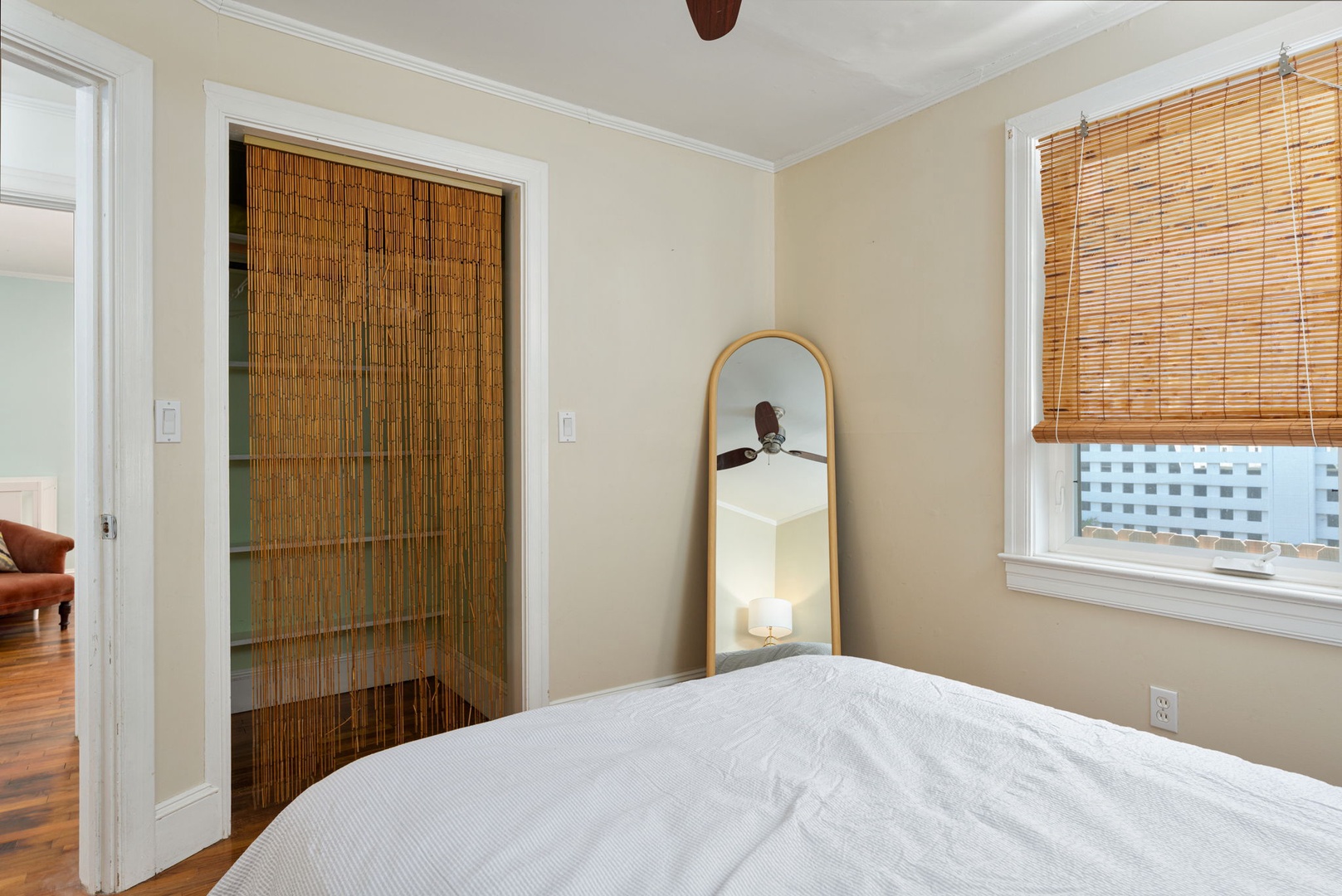 Drift off in this serene bedroom with warm bamboo accents and natural light filtering through your window blinds.