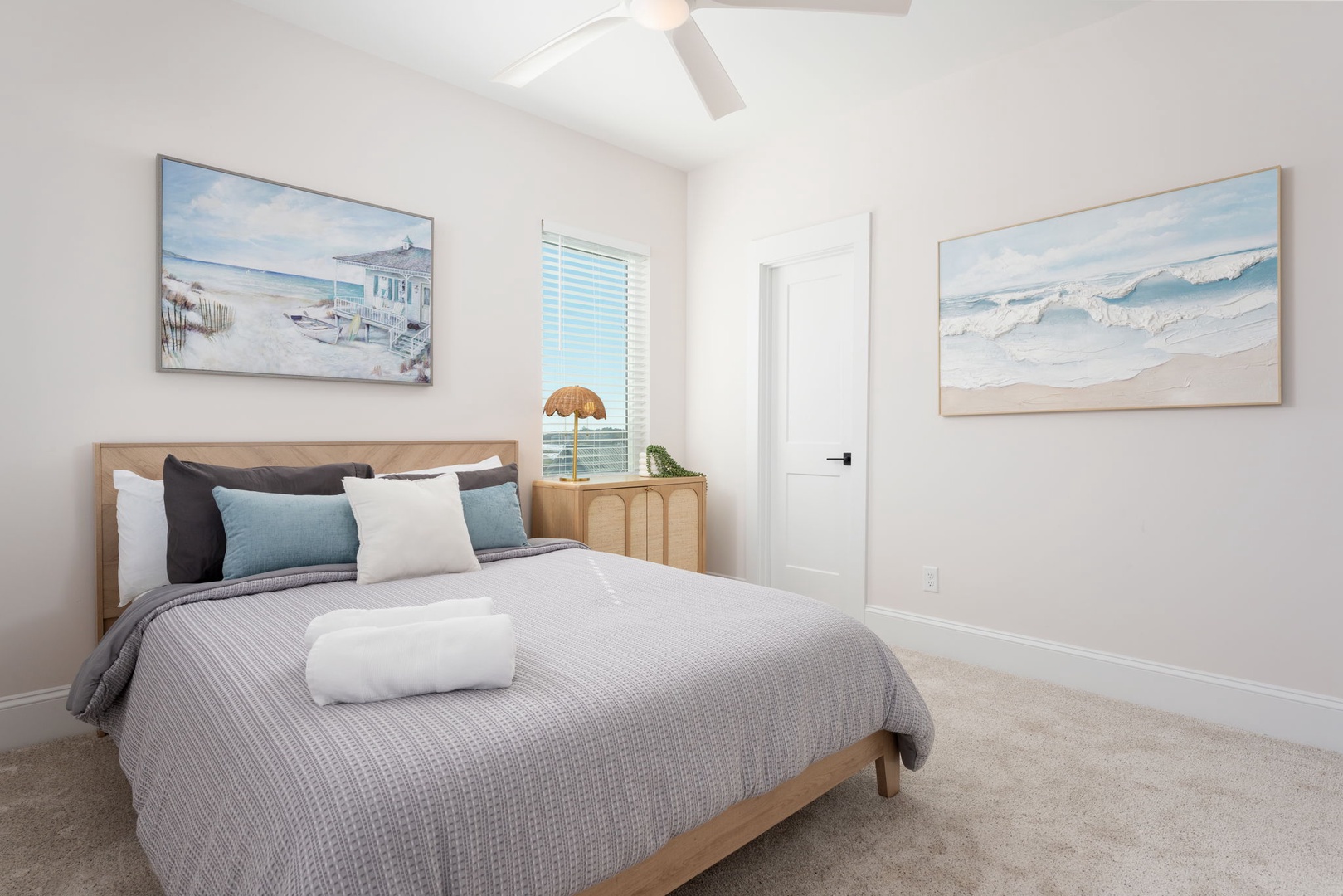 Drift off peacefully in your coastal-inspired bedroom, where soft ocean artwork and calming blues create the perfect retreat for restful nights.