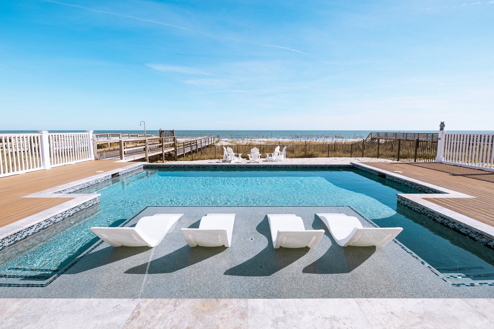 Dive into crystal-clear waters while soaking up ocean views from your private poolside paradise.