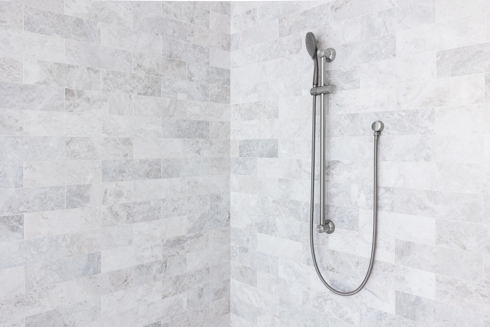 Step into your private spa-like shower with elegant marble tiles and modern fixtures for a refreshing start to your day.