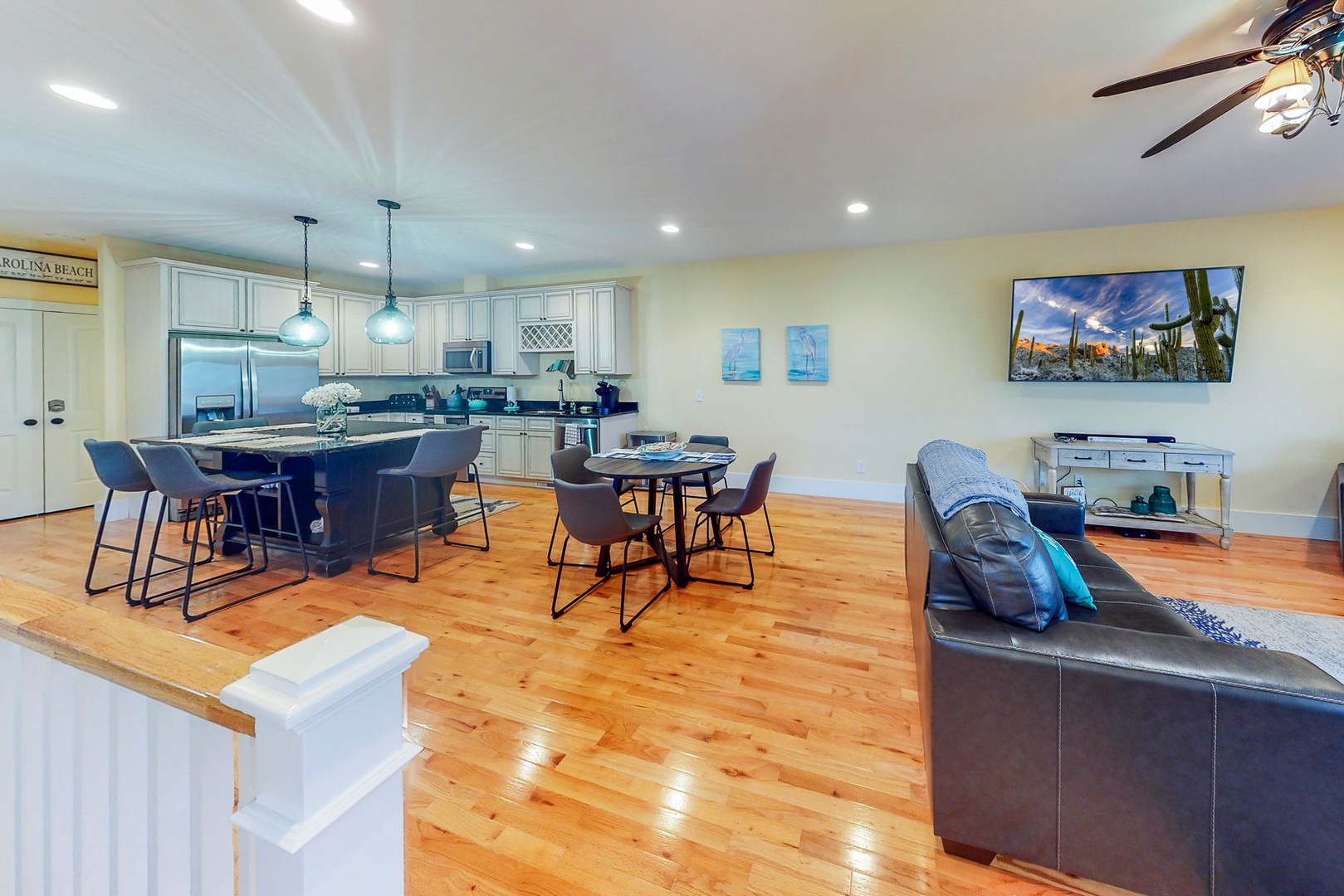Unwind in your spacious open-concept living area where gleaming hardwood floors flow seamlessly from kitchen to dining to lounge spaces.