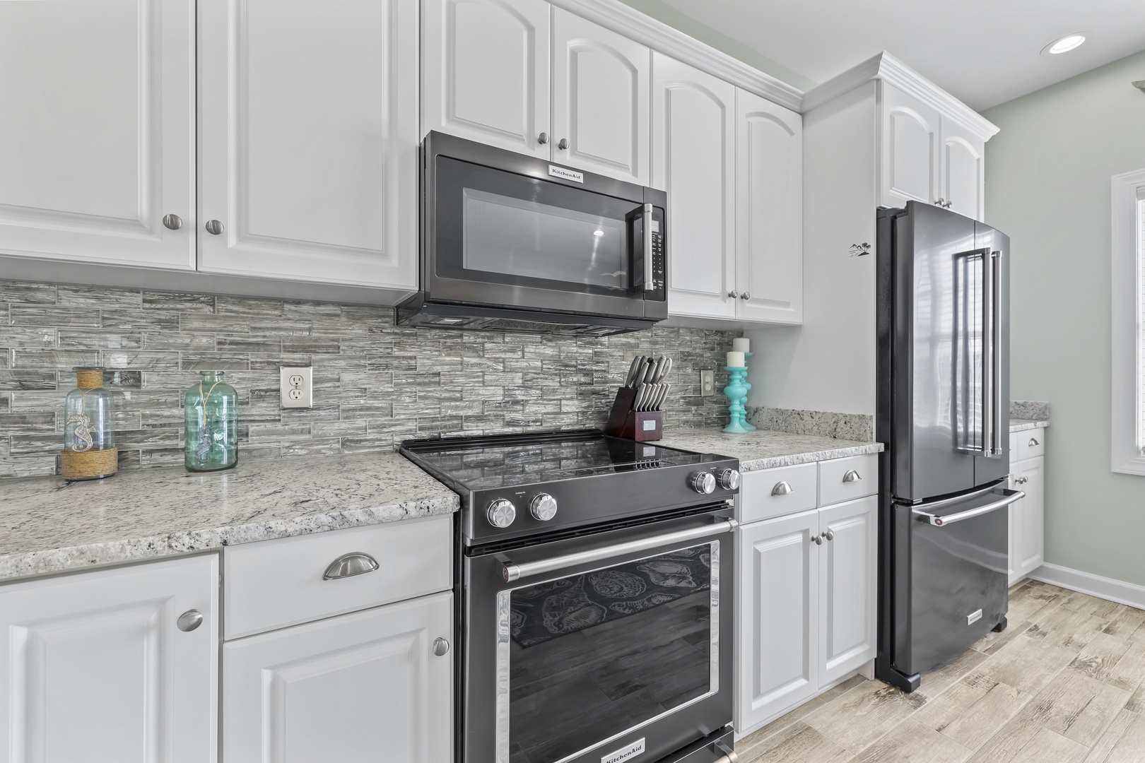 Your fully-equipped kitchen features modern stainless steel appliances, elegant granite counters, stylish tile backsplash, and ample cabinet space for all your vacation cooking needs.