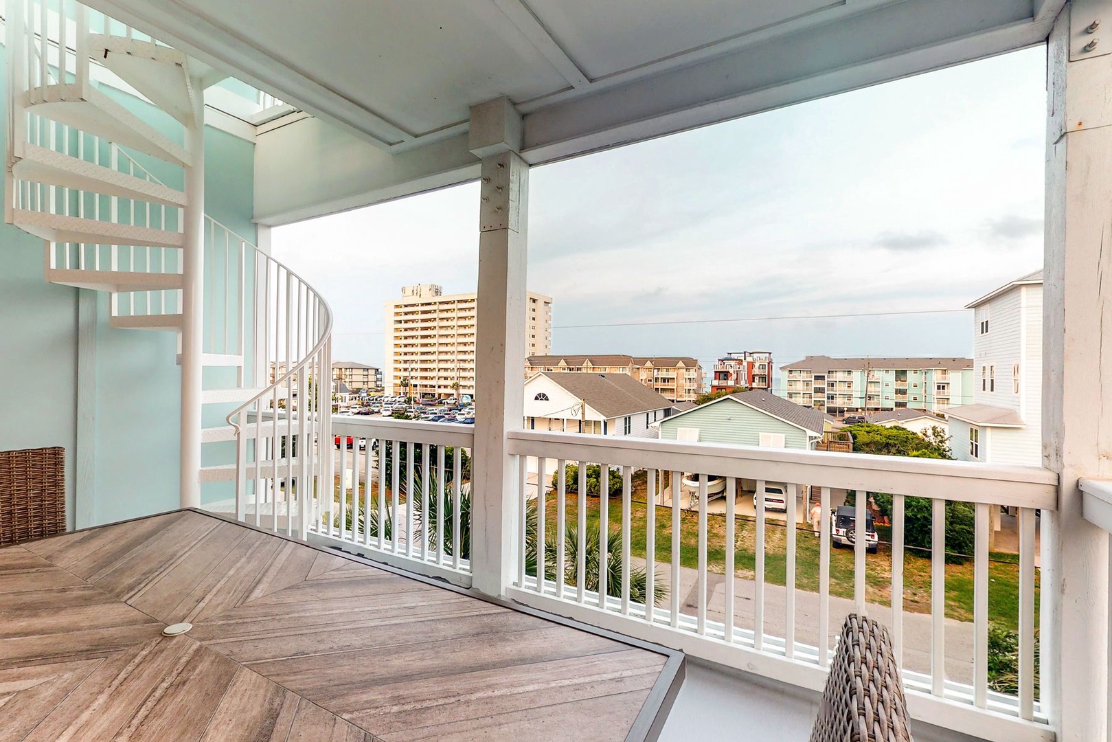 Step onto your private covered balcony and take in sweeping views of the charming coastal neighborhood stretching toward the horizon.