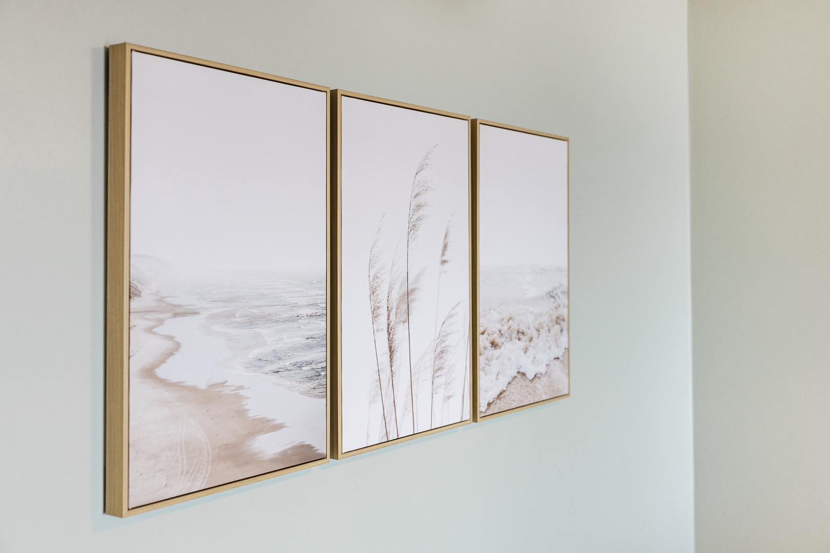 Soft coastal artwork creates a serene atmosphere in your space, featuring gentle beach scenes that bring tranquil seaside vibes indoors.