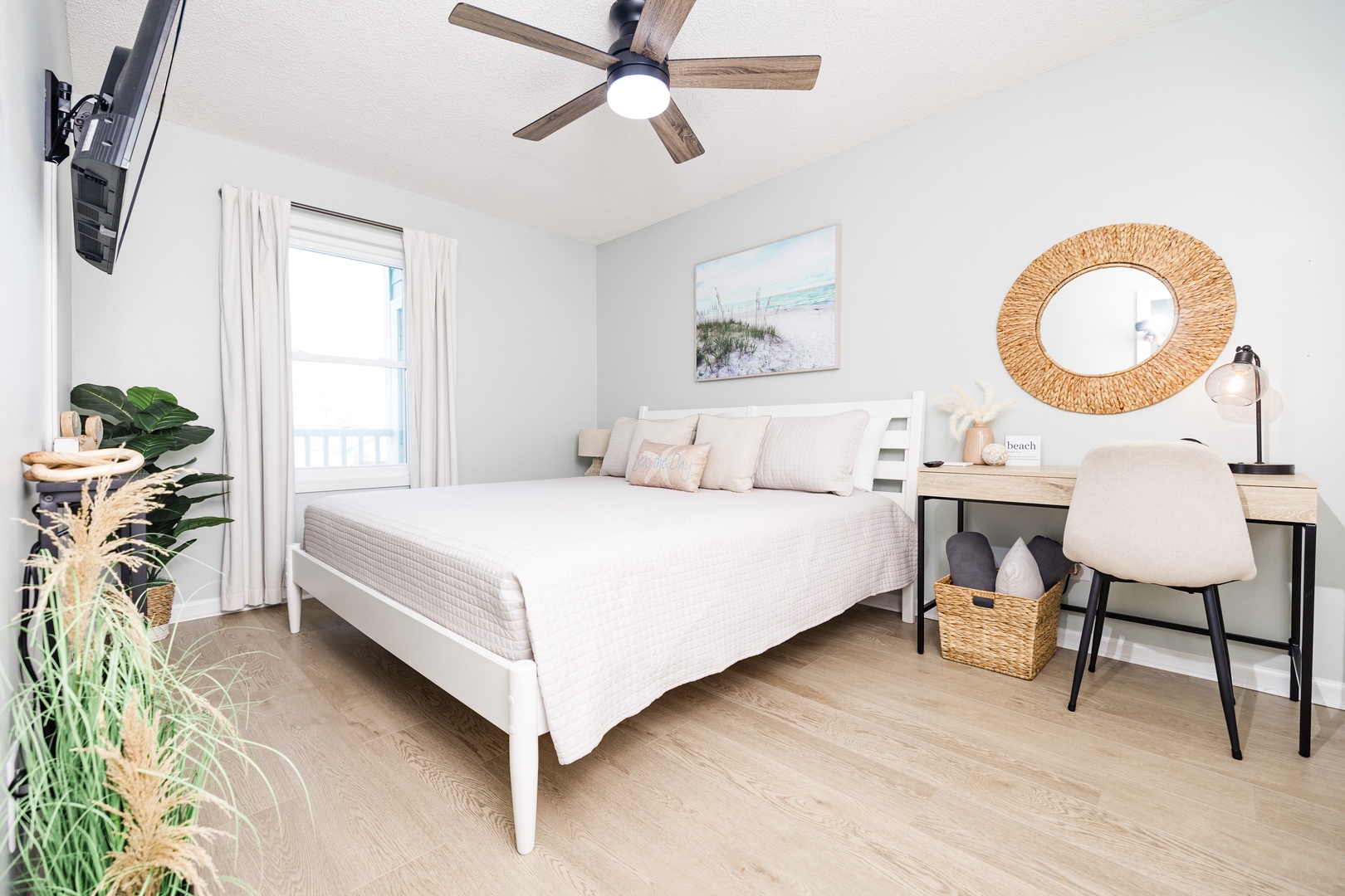 Drift off to sleep in your peaceful bedroom, complete with coastal artwork and modern workspace for ultimate comfort.