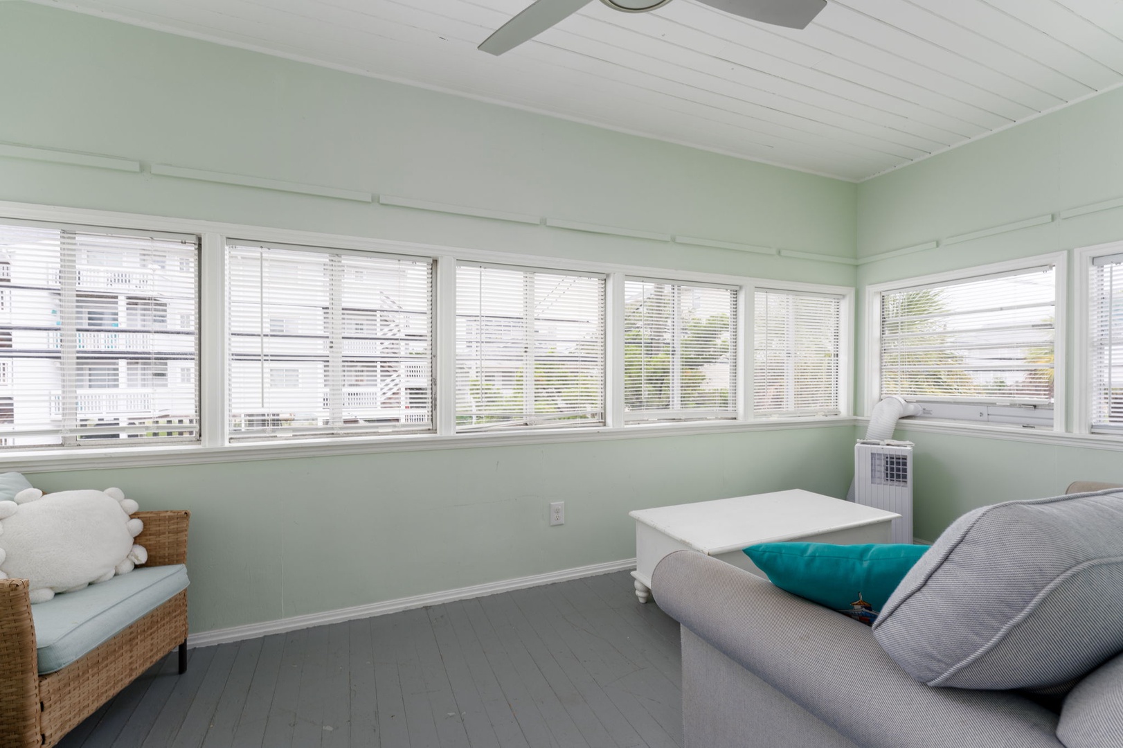 Relax in your bright bedroom with soothing mint walls, wraparound windows, and peaceful ceiling fan breezes.