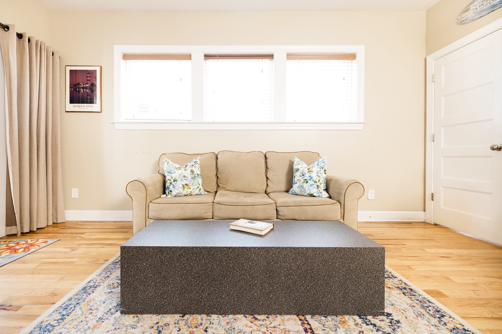 Unwind on your plush sofa with morning coffee while natural light streams through triple windows, creating a serene retreat.